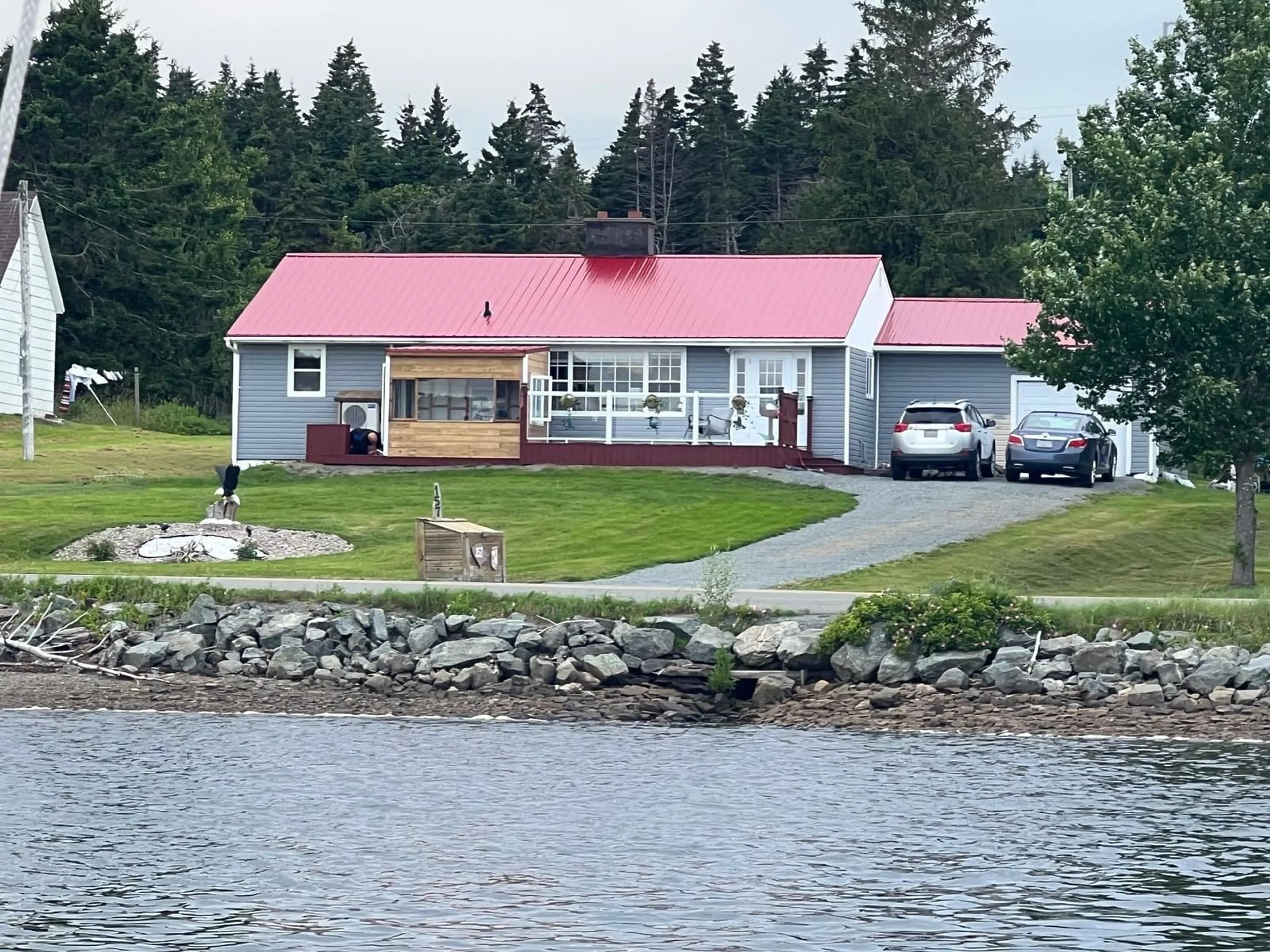 A pic from outside/outdoor area/front of a property/back of a property/a pic from drone, water/lake/river/ocean view for 157 North Side River Bourgeois Rd, River Bourgeois Nova Scotia B0E 2X0