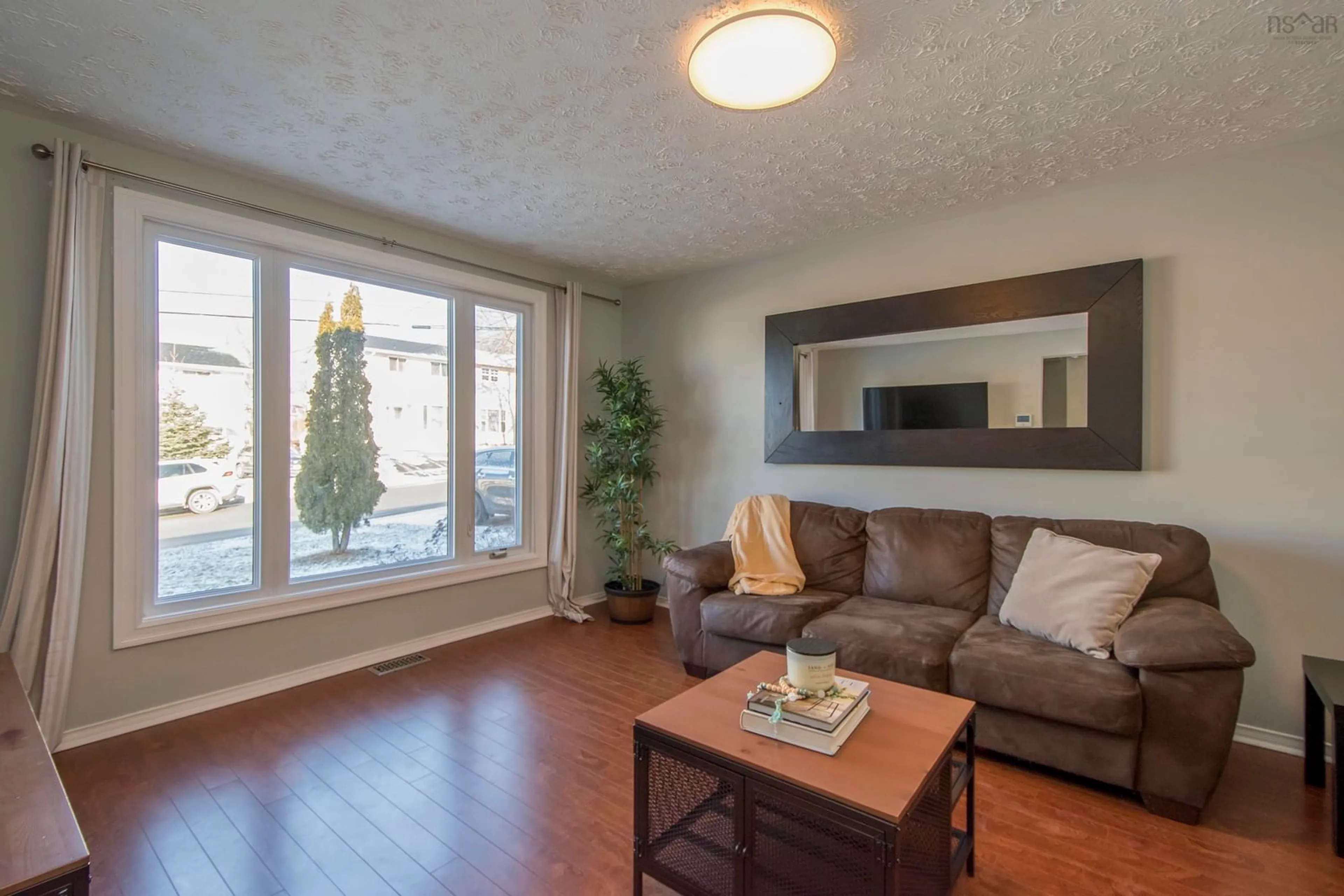 Living room with furniture, wood/laminate floor for 18 Brompton Rd, Dartmouth Nova Scotia B2W 4M6