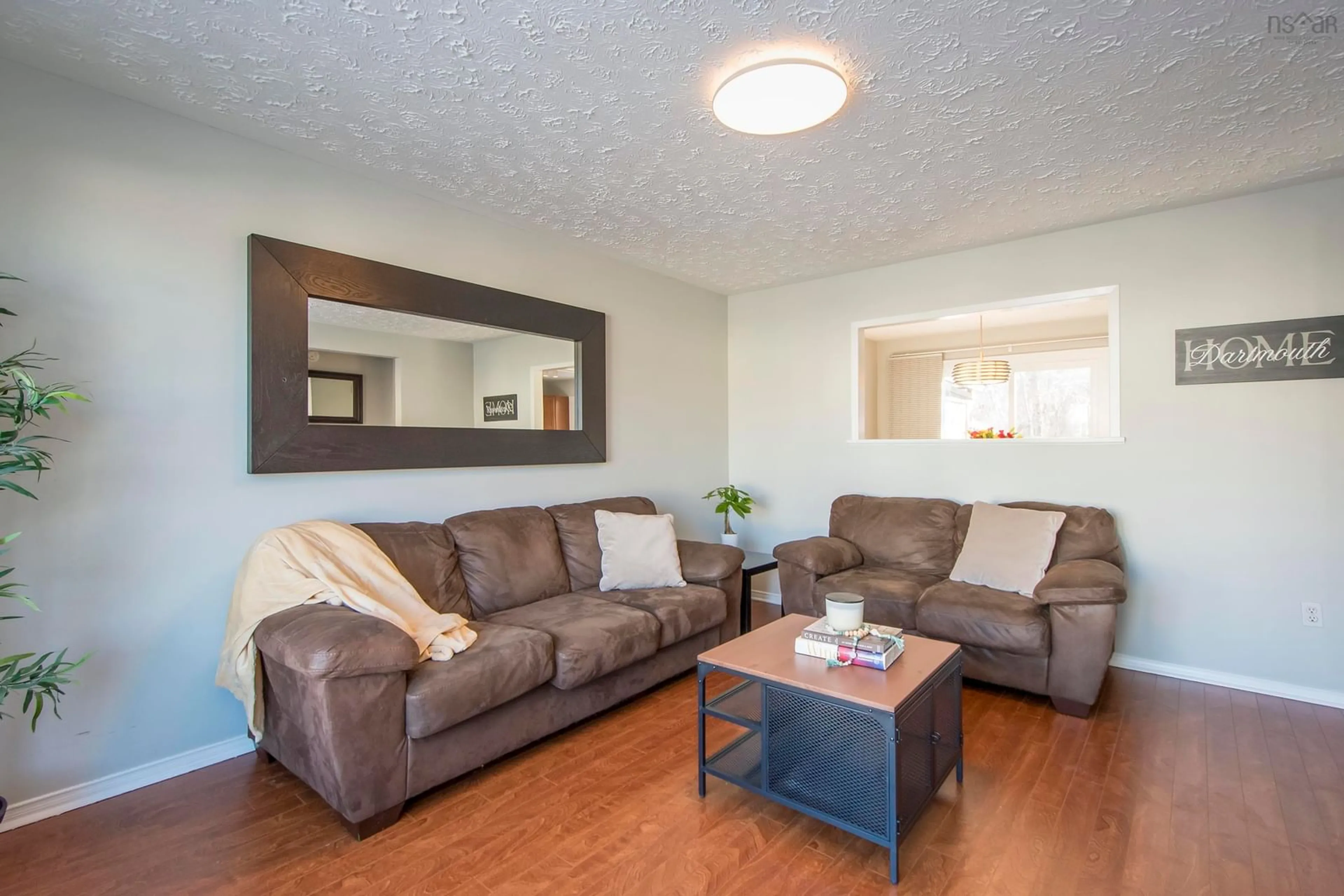 Living room with furniture, wood/laminate floor for 18 Brompton Rd, Dartmouth Nova Scotia B2W 4M6