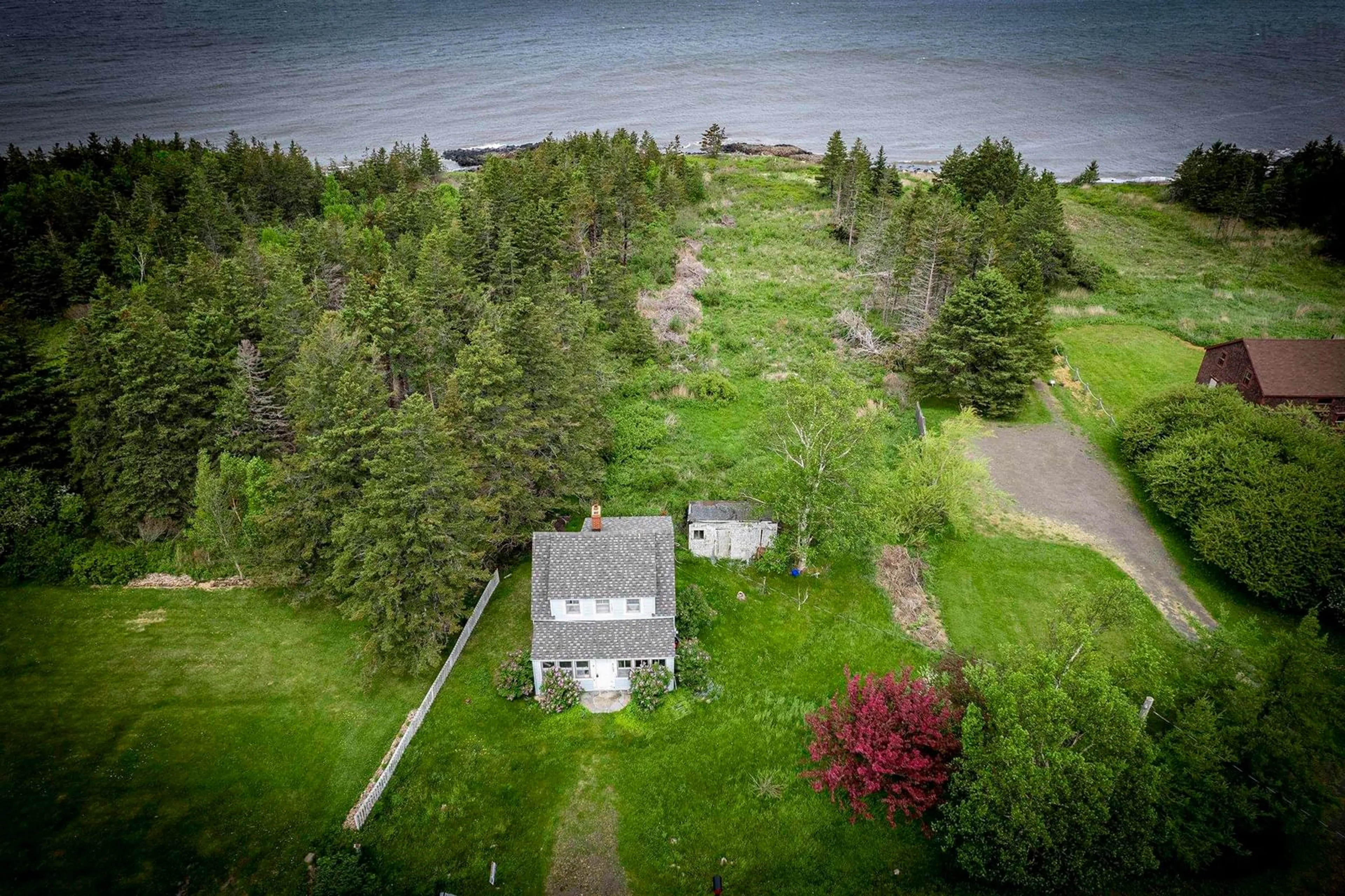 A pic from outside/outdoor area/front of a property/back of a property/a pic from drone, water/lake/river/ocean view for 6165 Shore Rd, Youngs Cove Nova Scotia B0S 1A0