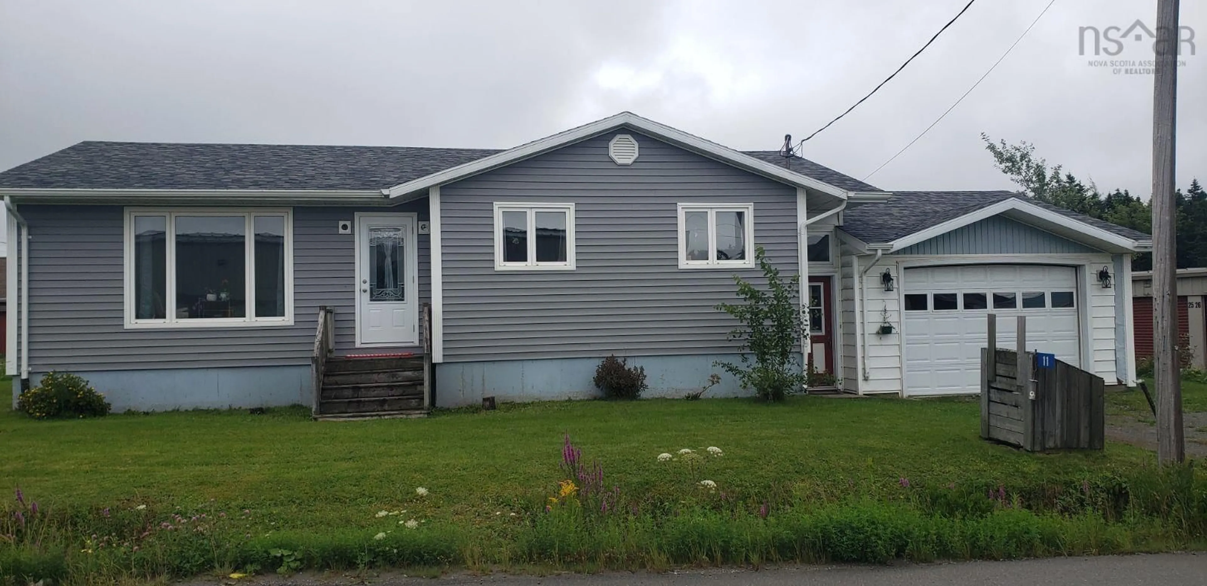 Home with vinyl exterior material, street for 11 Toulouse St, St. Peter's Nova Scotia B0E 3B0