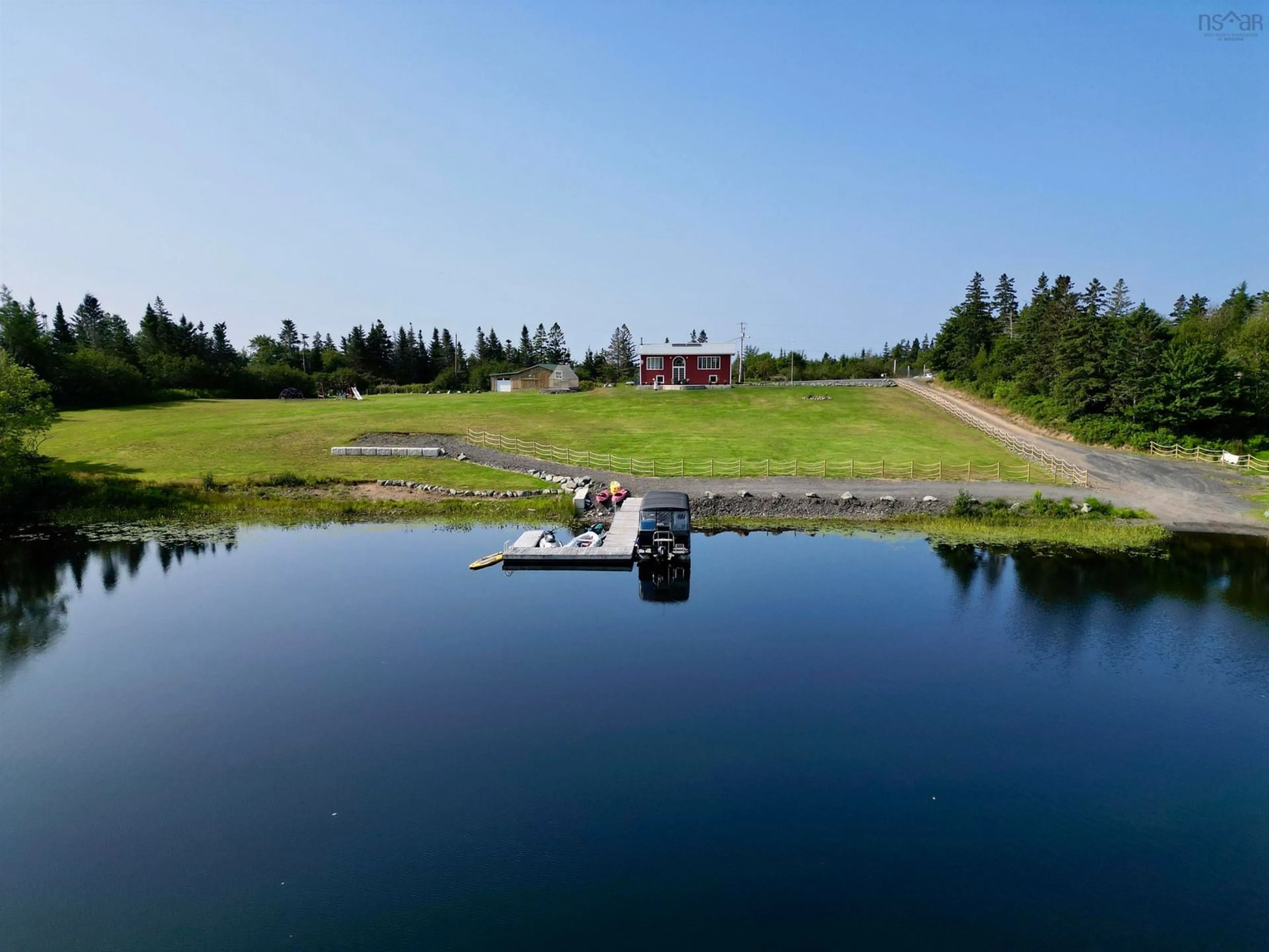 A pic from outside/outdoor area/front of a property/back of a property/a pic from drone, water/lake/river/ocean view for 207 Lake Rd, West Arichat Nova Scotia B0E 3J0