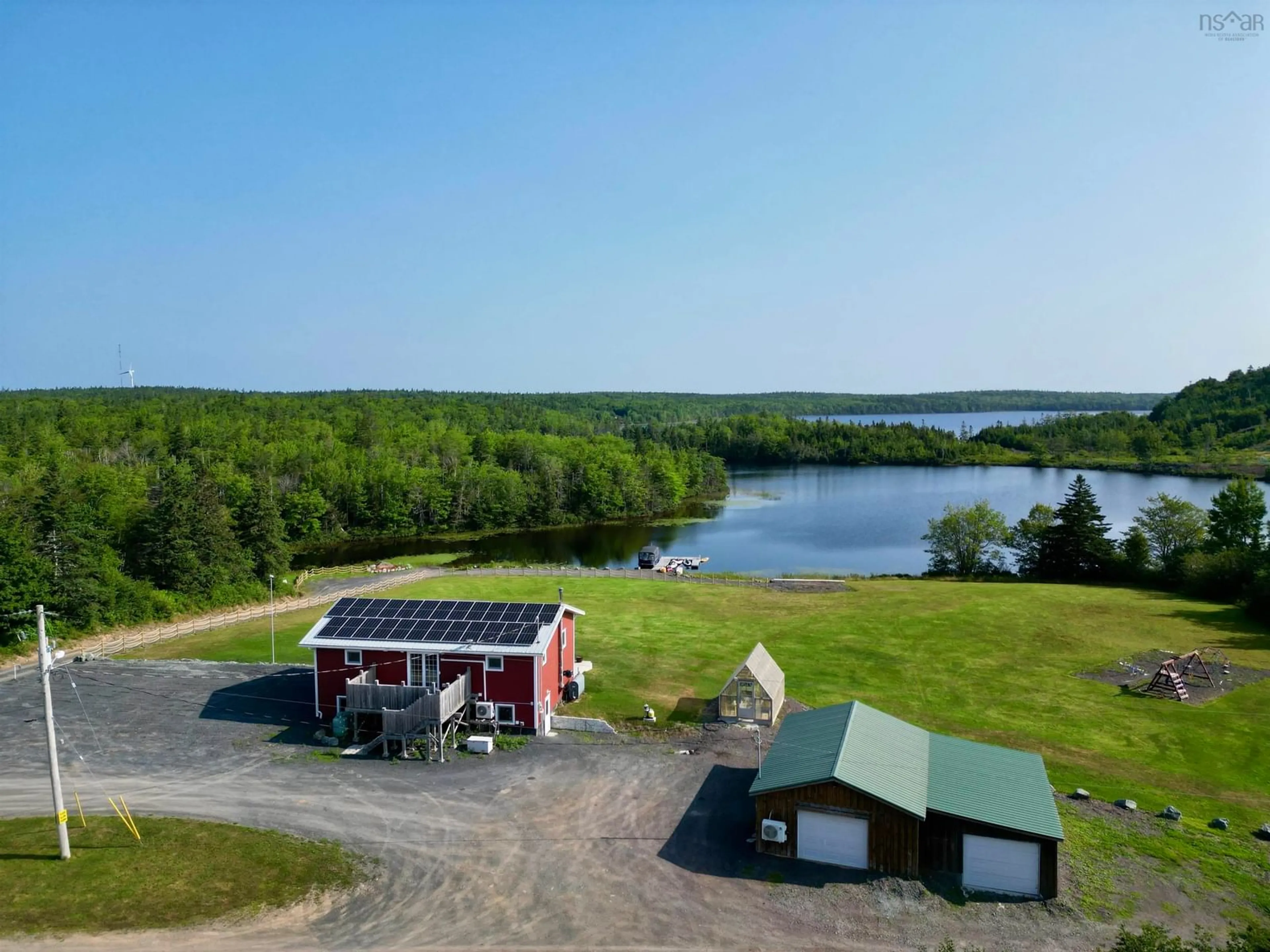 A pic from outside/outdoor area/front of a property/back of a property/a pic from drone, water/lake/river/ocean view for 207 Lake Rd, West Arichat Nova Scotia B0E 3J0