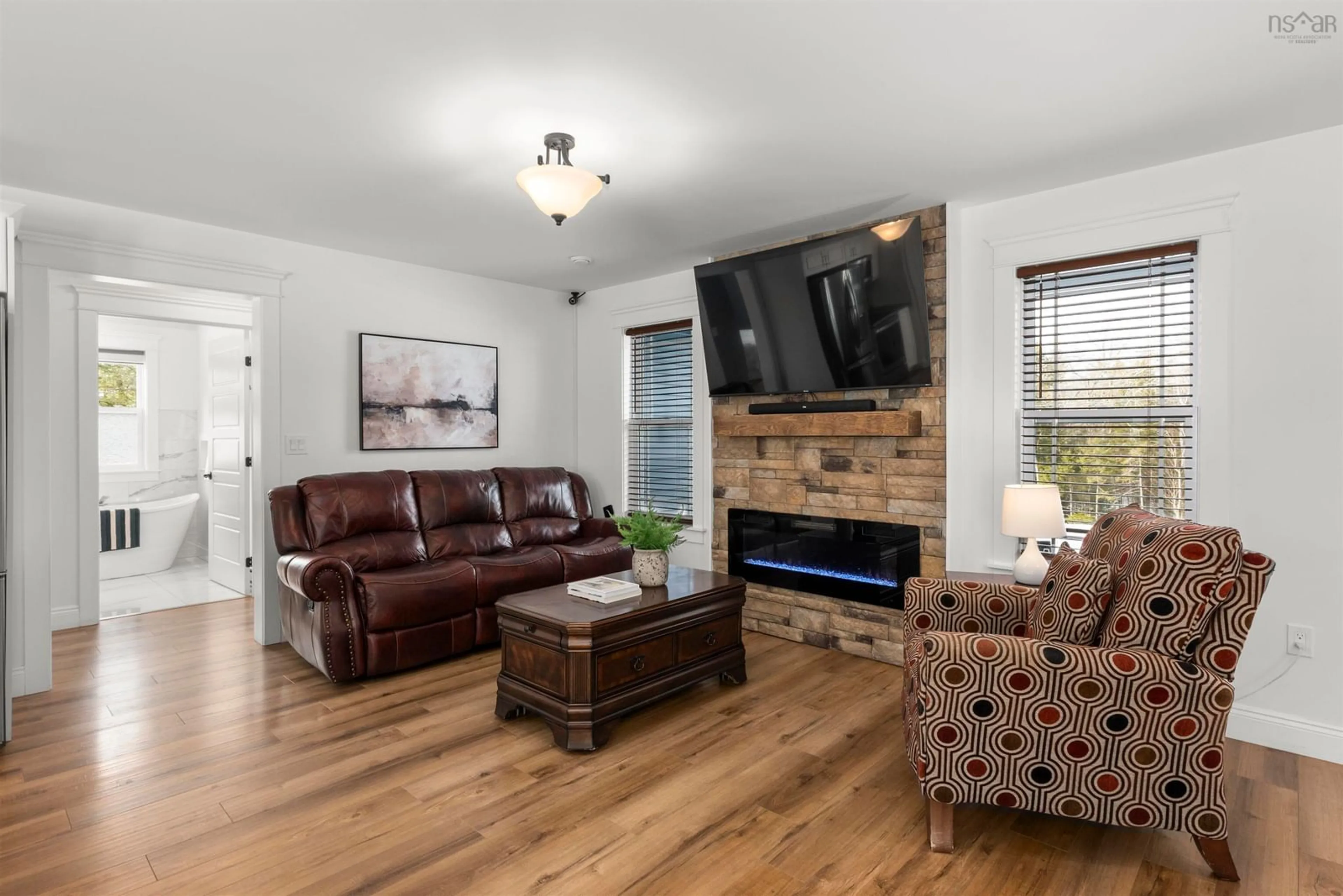 Living room with furniture, wood/laminate floor for 458 Calderwood Dr, Wellington Nova Scotia B2T 0S2