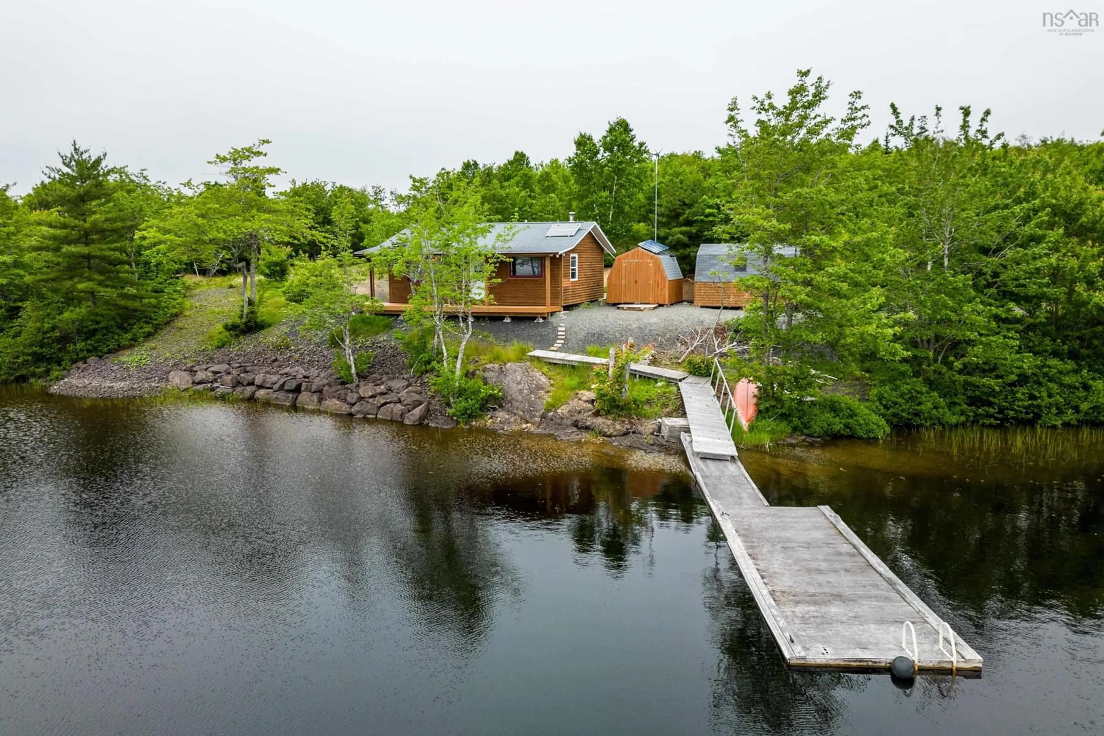 A pic from outside/outdoor area/front of a property/back of a property/a pic from drone, water/lake/river/ocean view for 469 South Grand Lake Rd, Arichat Nova Scotia B0E 1A0