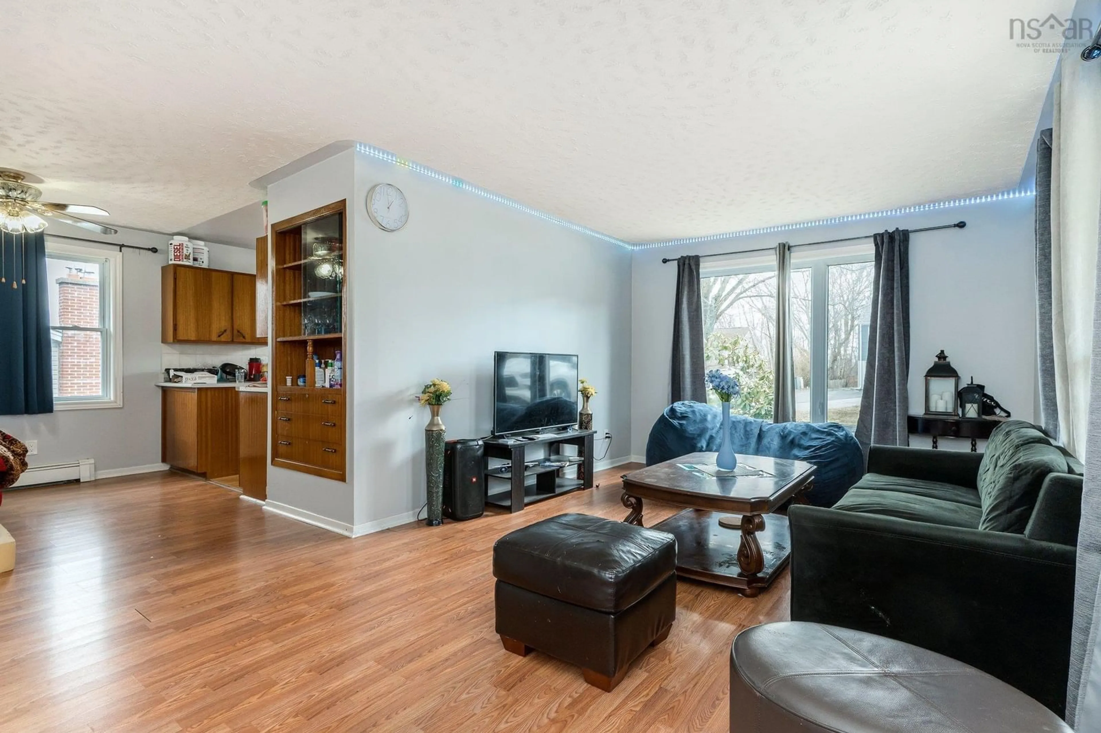 Living room with furniture, wood/laminate floor for 81 Frederick Ave, Halifax Nova Scotia B3N 2K9