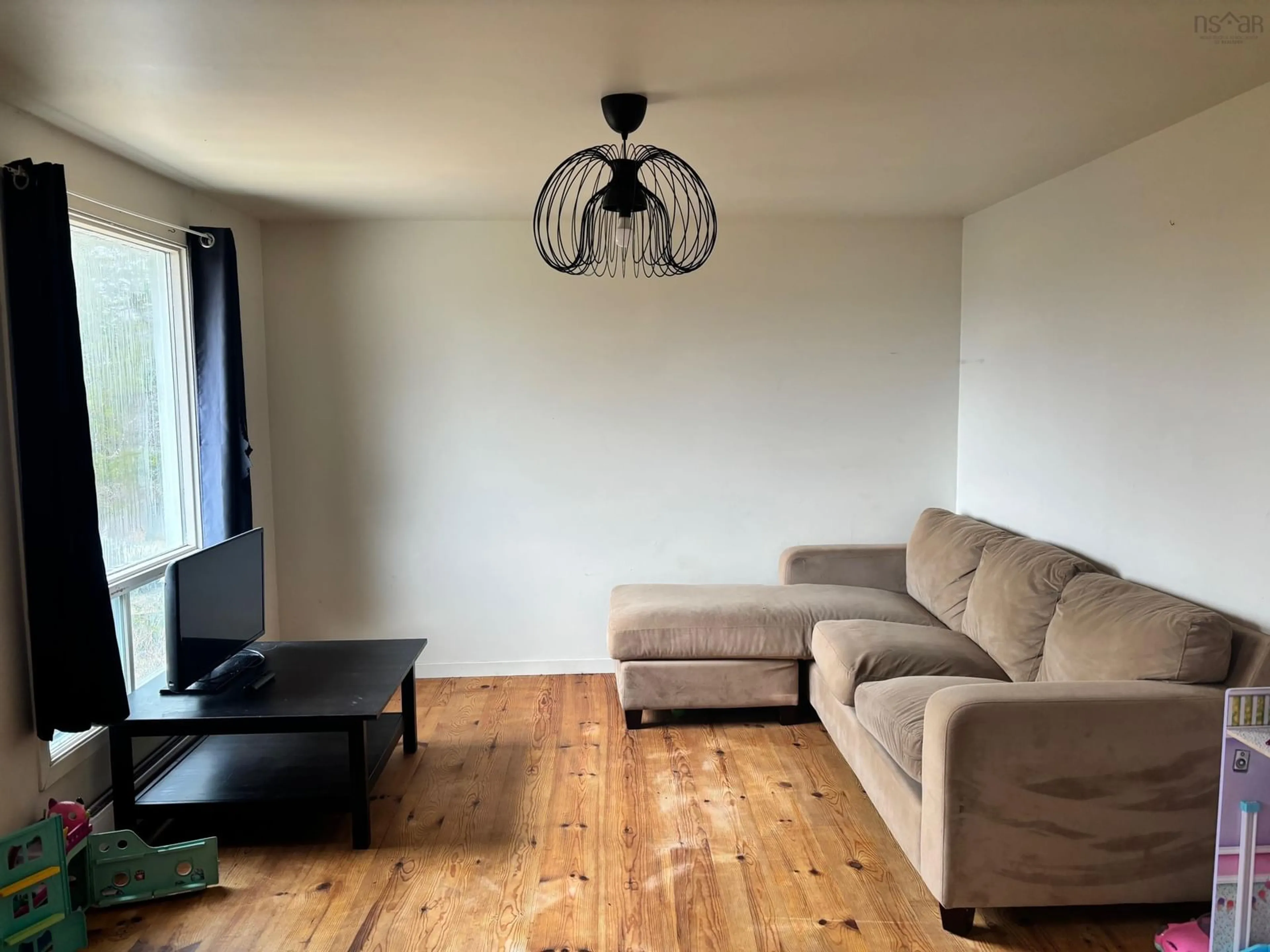 Living room with furniture, wood/laminate floor for 312 East River Rd, Sheet Harbour Nova Scotia B0J 3B0