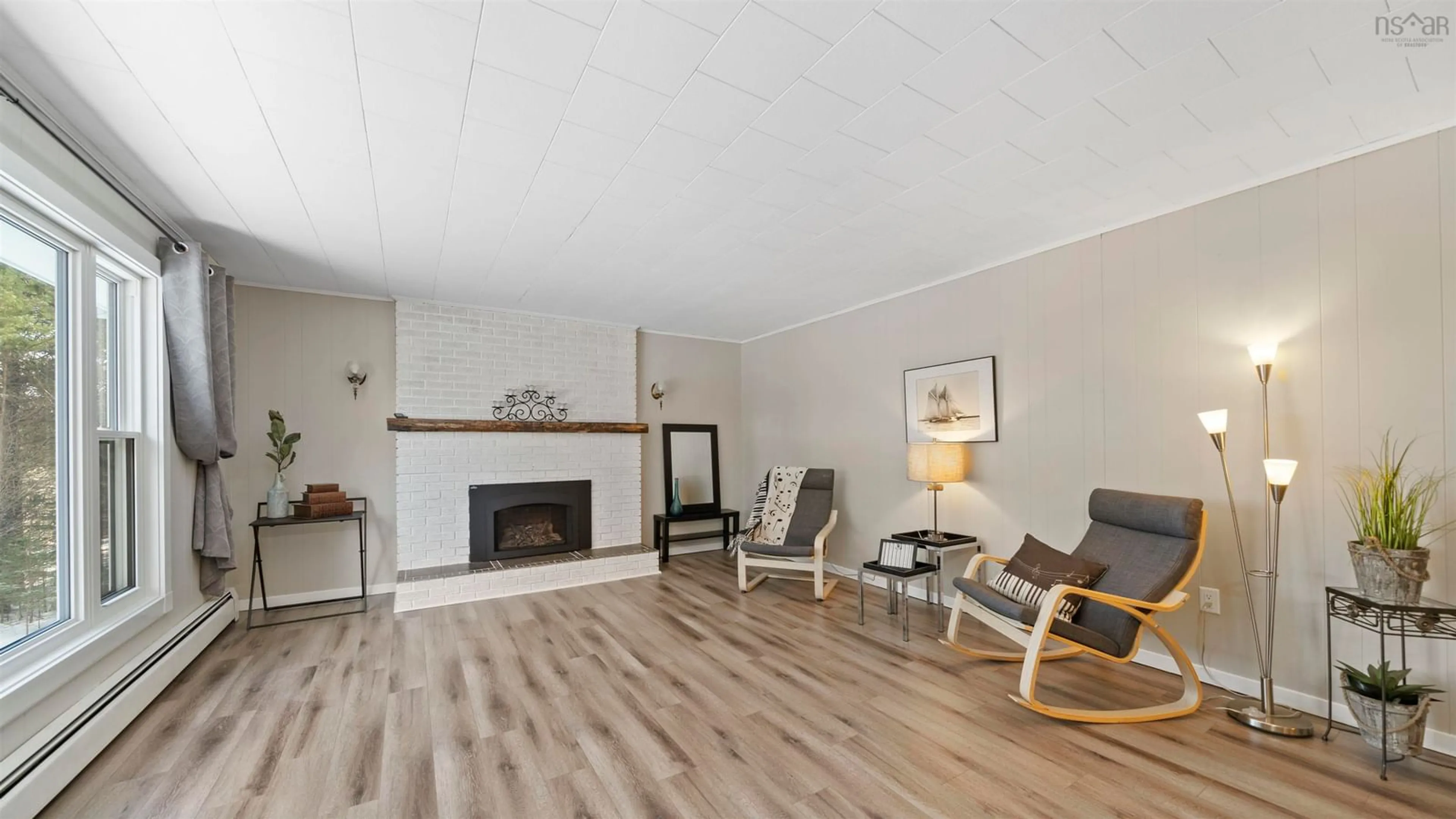 Living room with furniture, wood/laminate floor for 213 Lower Grant Rd, Chester Basin Nova Scotia B0J 1K0
