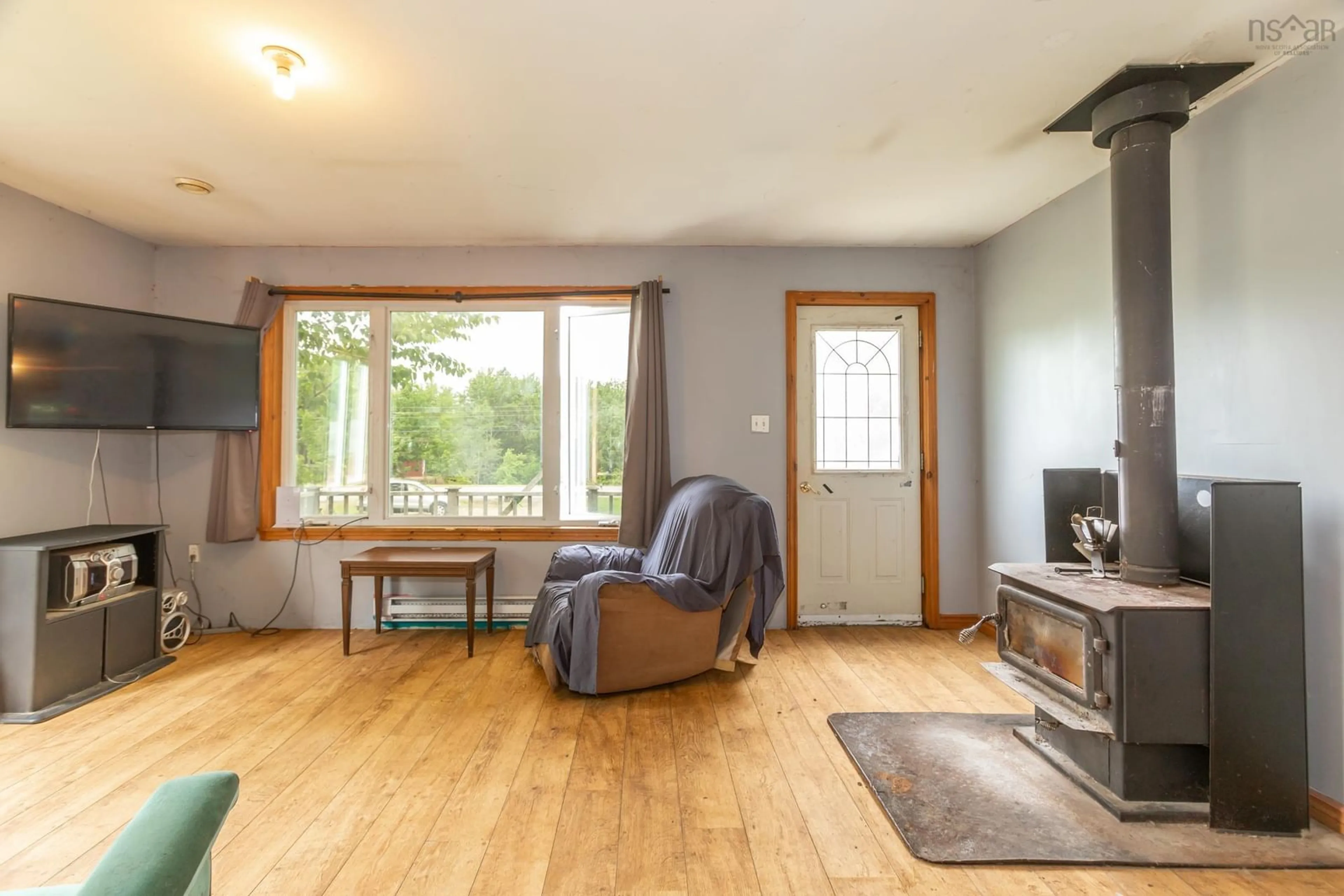 Living room with furniture, wood/laminate floor for 3518 Shore Road West, Hillsburn Nova Scotia B0S 1A0
