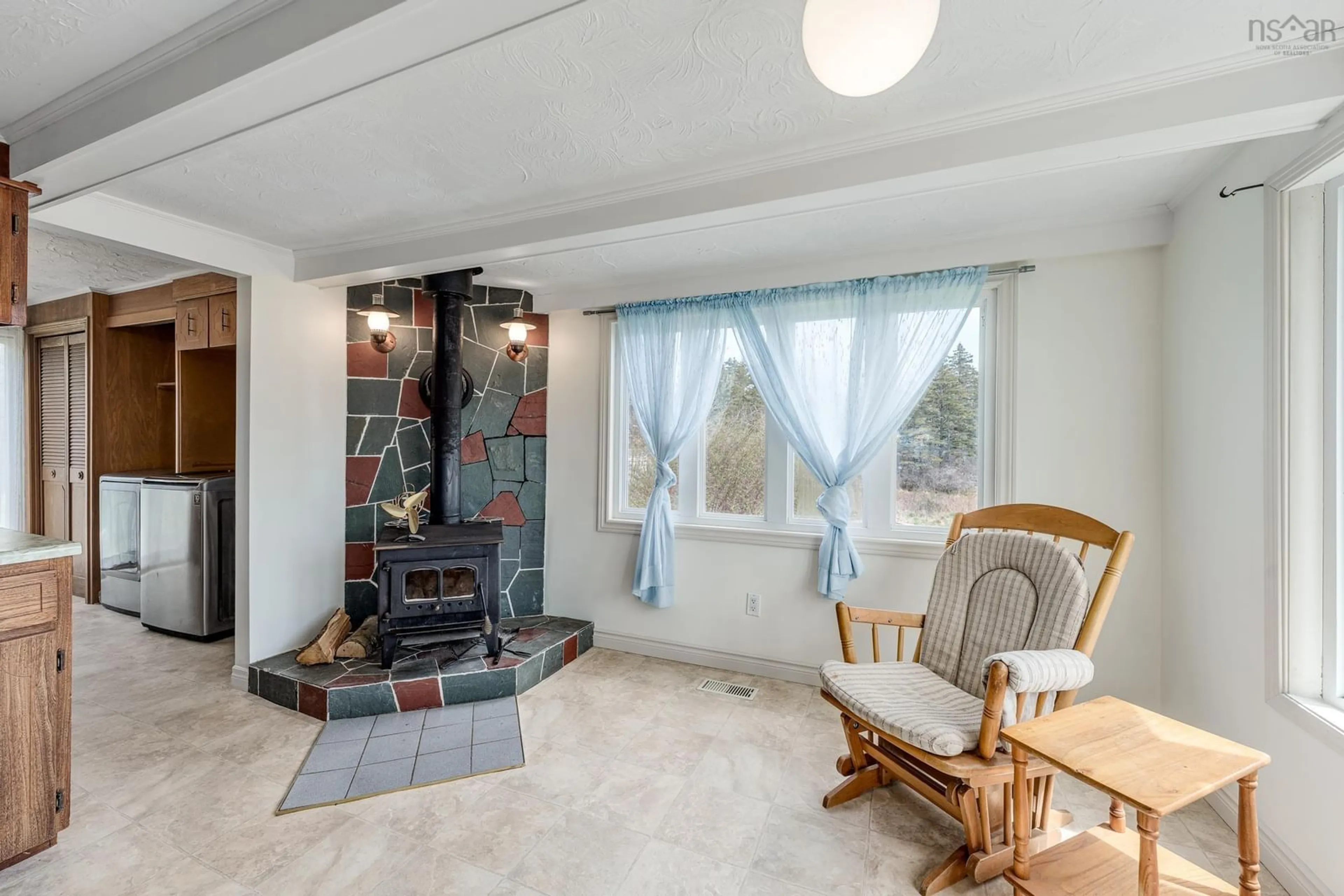 Living room with furniture, ceramic/tile floor for 7220 Highway 3, Ste. Anne Du Ruisseau Nova Scotia B0W 2X0