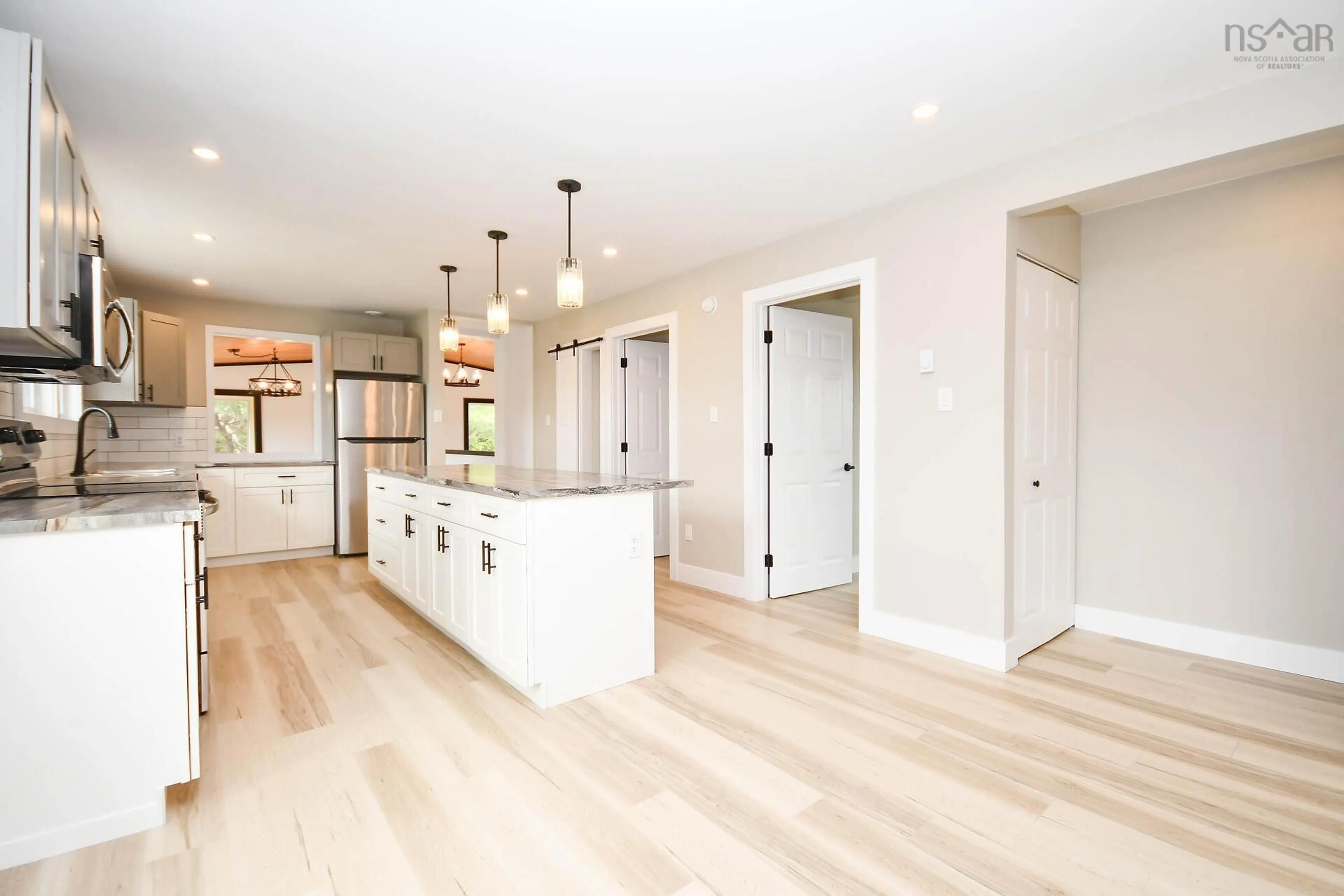 Open concept kitchen, wood/laminate floor for 839 East Chezzetcook Rd, East Chezzetcook Nova Scotia B0J 2L0
