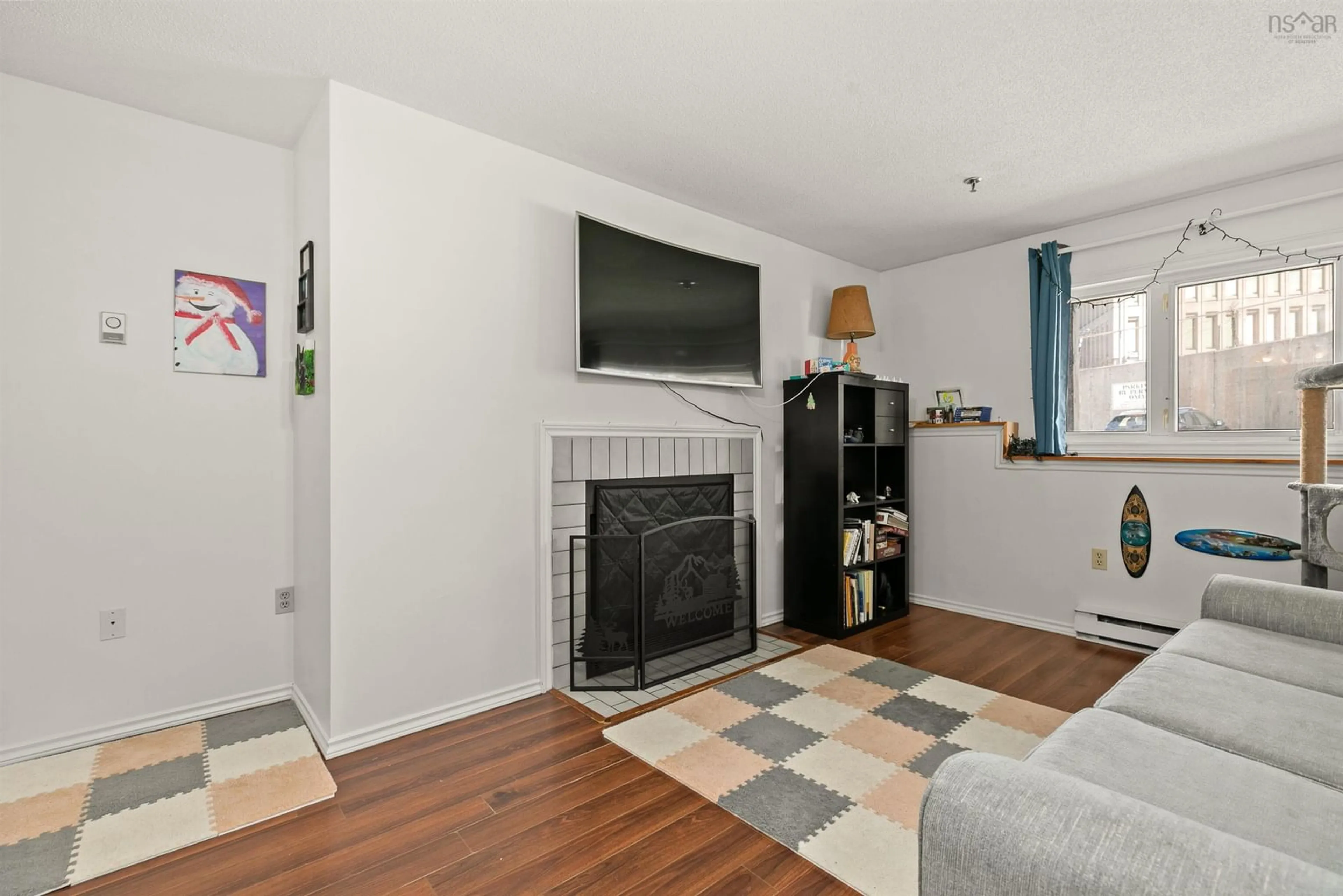 Living room with furniture, wood/laminate floor for 3600 John Parr Dr #220, Halifax Nova Scotia B3K 5V3
