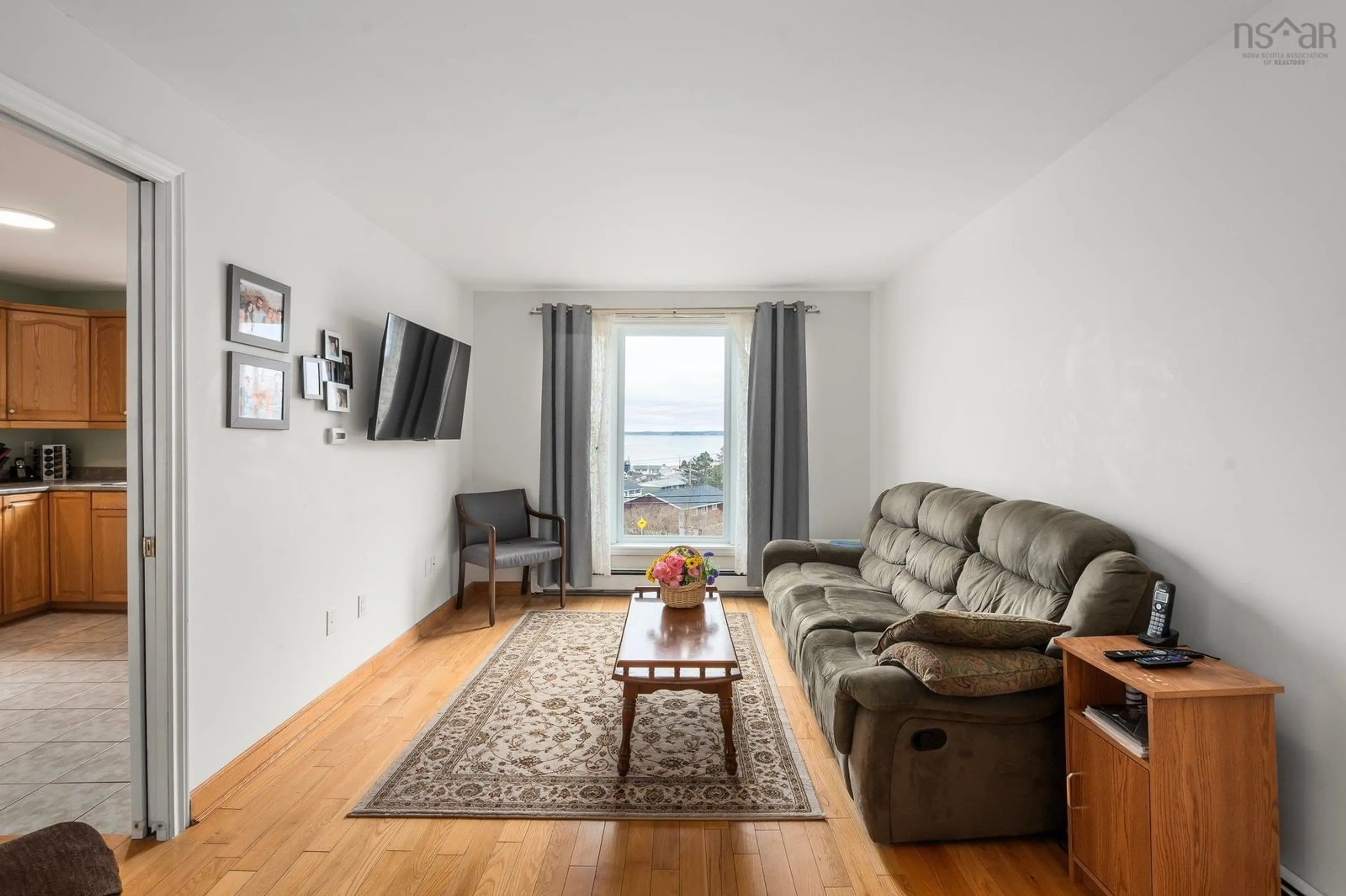 Living room with furniture, wood/laminate floor for 2016 Caldwell Rd, Eastern Passage Nova Scotia B3G 1H9