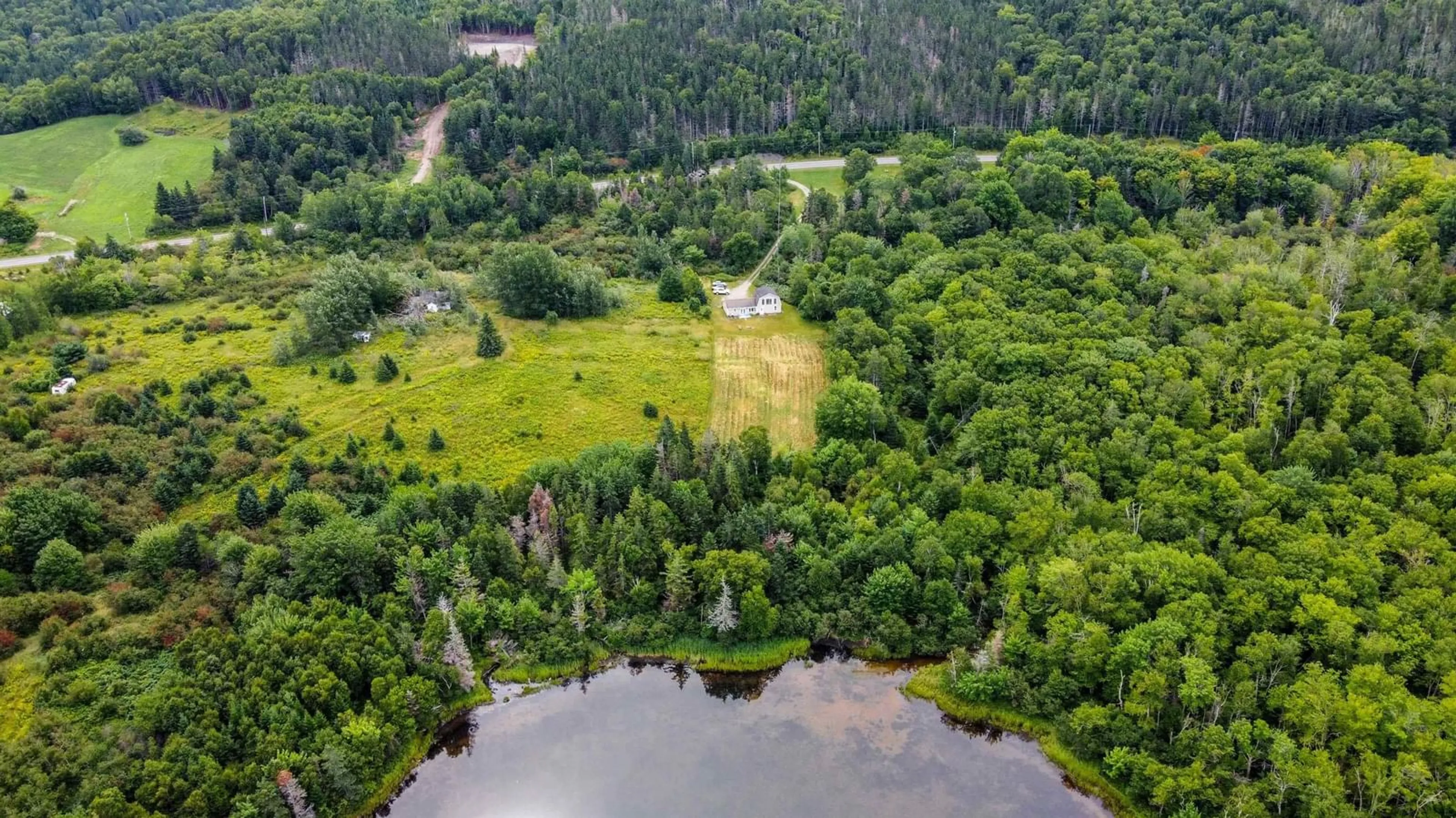 A pic from outside/outdoor area/front of a property/back of a property/a pic from drone, water/lake/river/ocean view for 8004 East Bay Highway, Big Pond Centre Nova Scotia B1J 1Z4