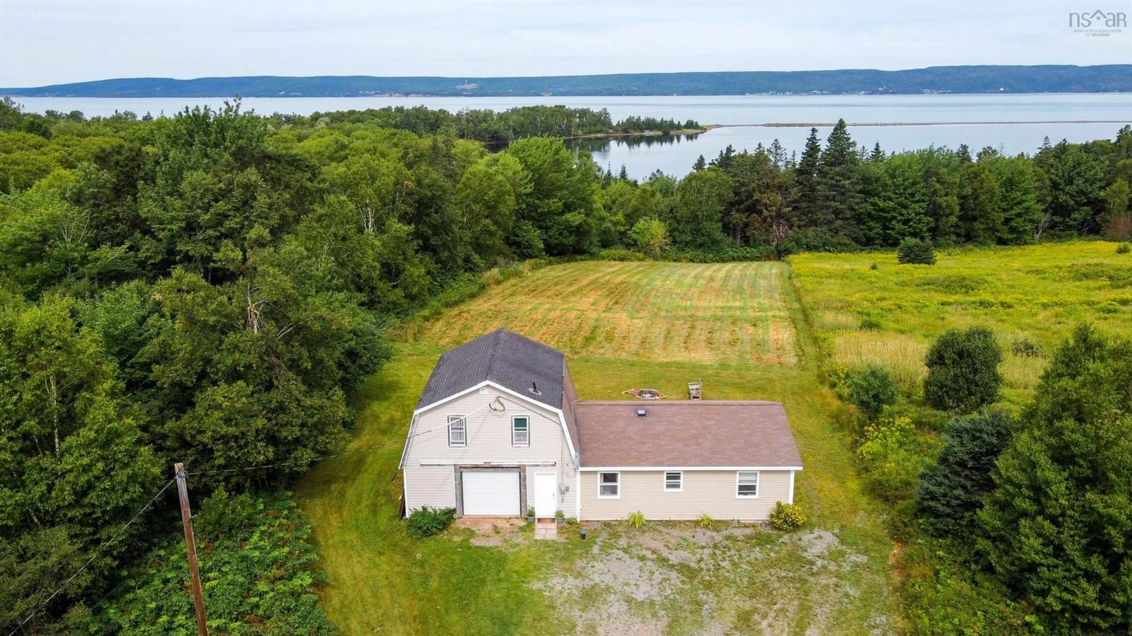 A pic from outside/outdoor area/front of a property/back of a property/a pic from drone, water/lake/river/ocean view for 8004 East Bay Highway, Big Pond Centre Nova Scotia B1J 1Z4