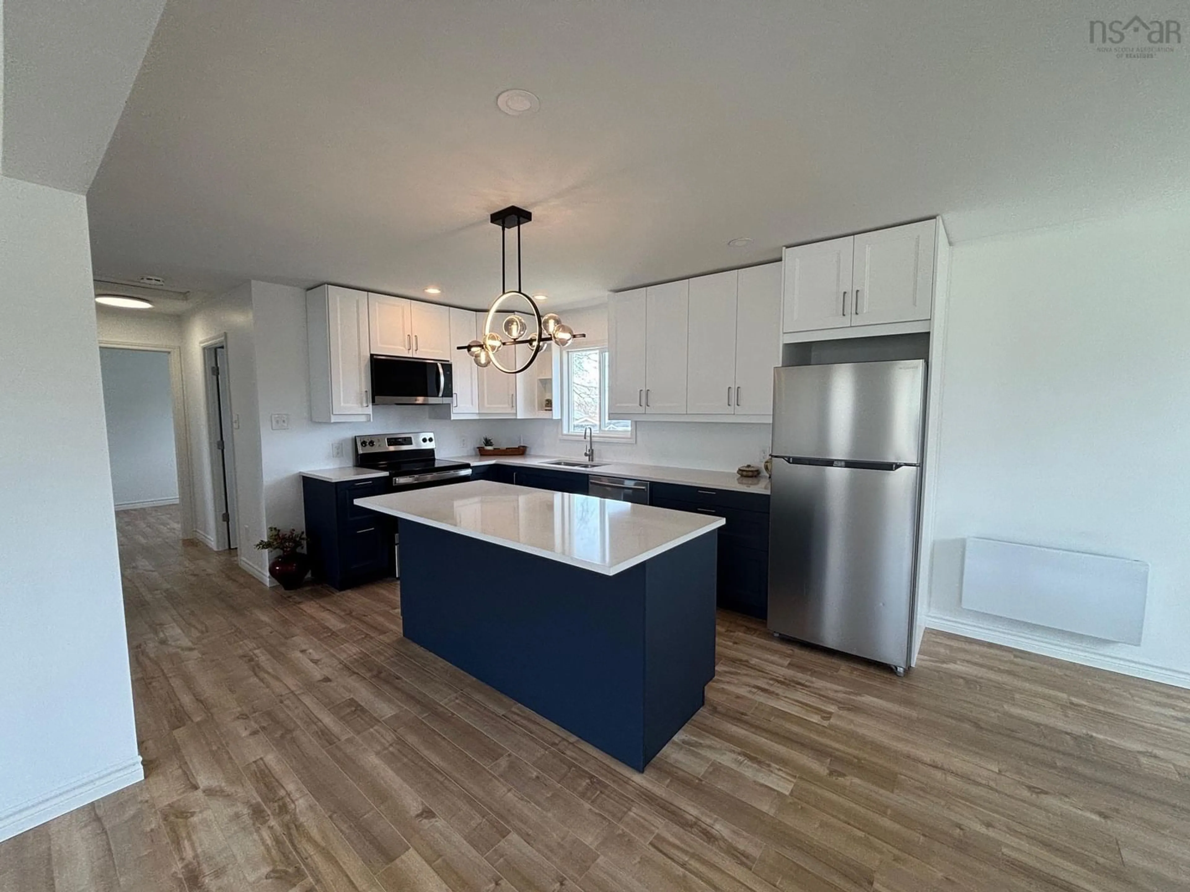 Open concept kitchen, wood/laminate floor for 3511 Mary Ave, New Waterford Nova Scotia B1H 2A5