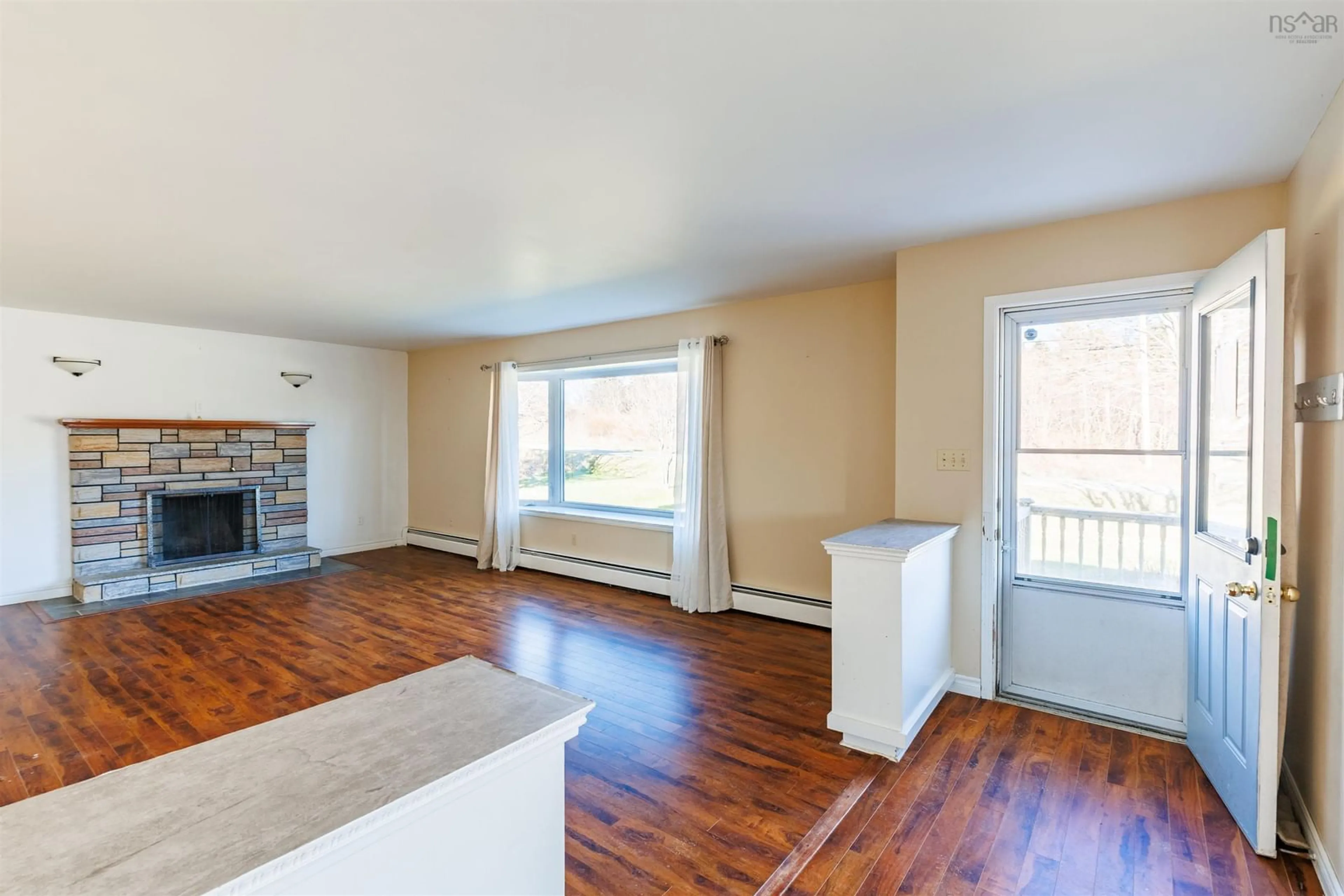 Living room with furniture, wood/laminate floor for 6221 1 Hwy, Mavillette Nova Scotia B0W 2H0