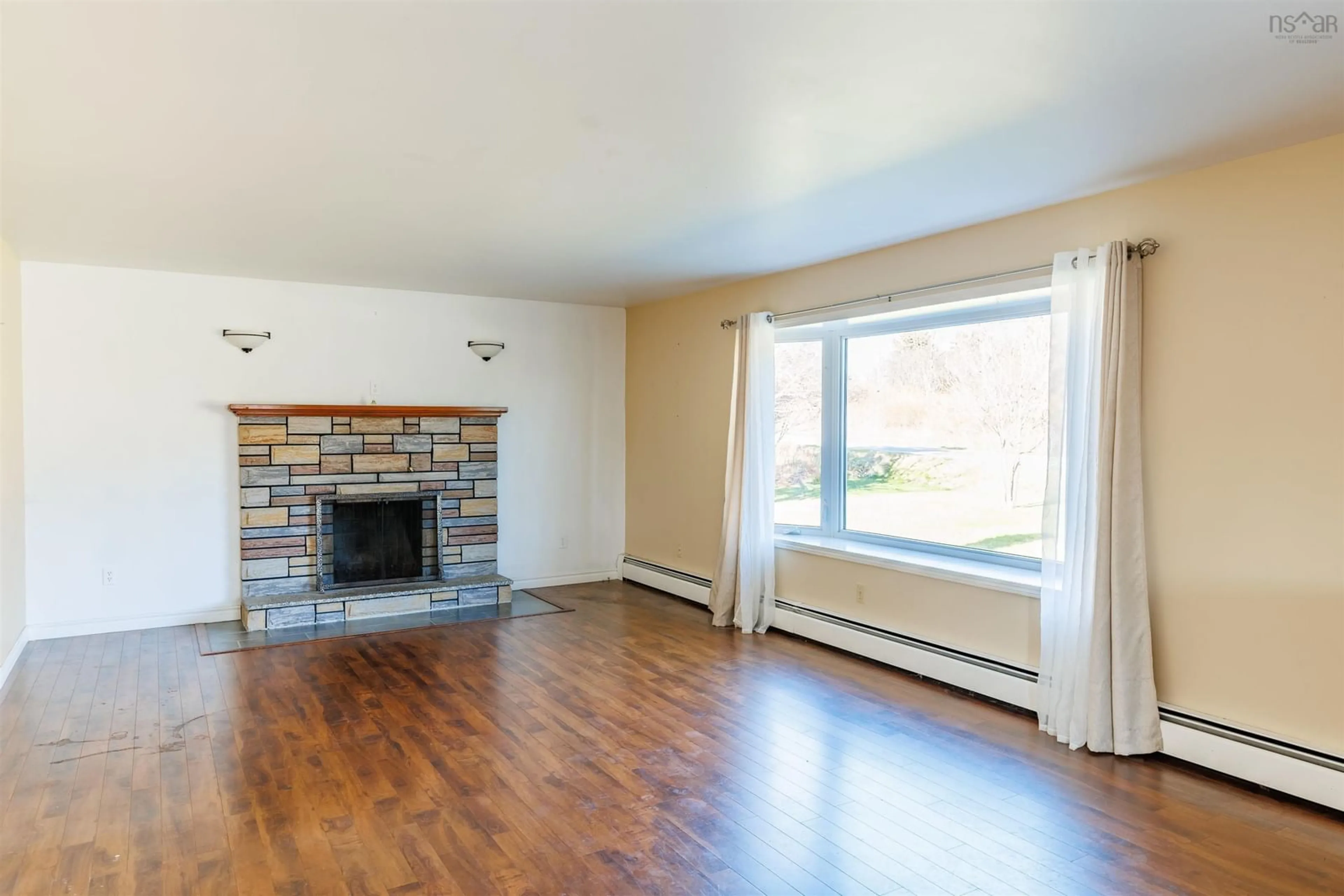 Living room with furniture, wood/laminate floor for 6221 1 Hwy, Mavillette Nova Scotia B0W 2H0