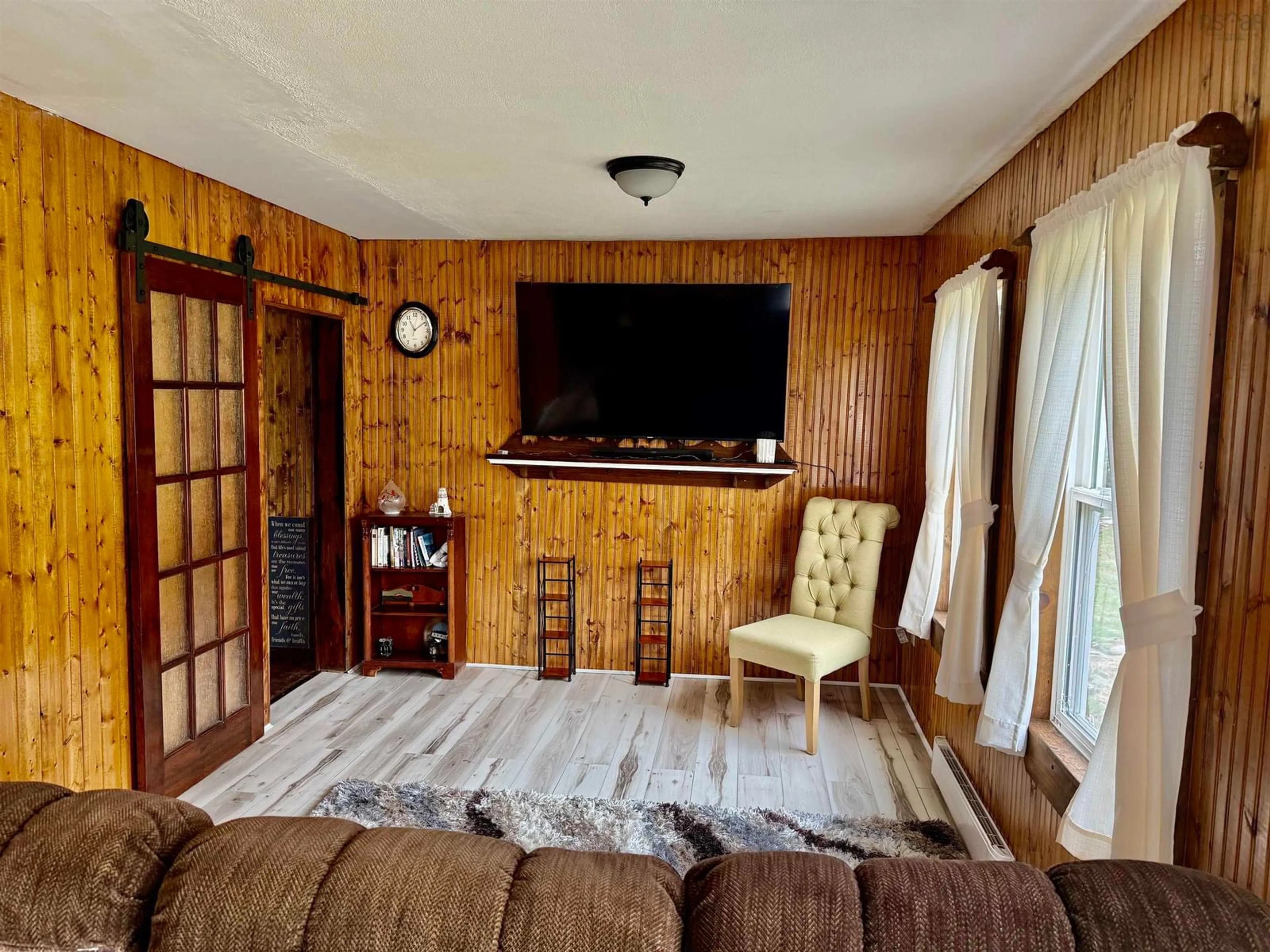 Living room with furniture, wood/laminate floor for 4333 Shore Rd, Ingomar Nova Scotia B0T 1H0