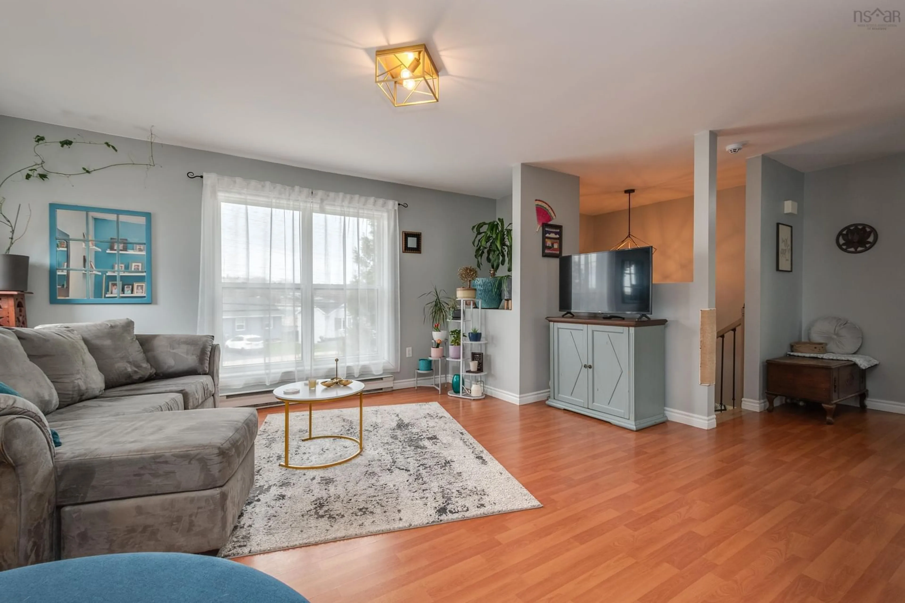 Living room with furniture, wood/laminate floor for 56 Lucasville Rd, Middle Sackville Nova Scotia B4E 3E8