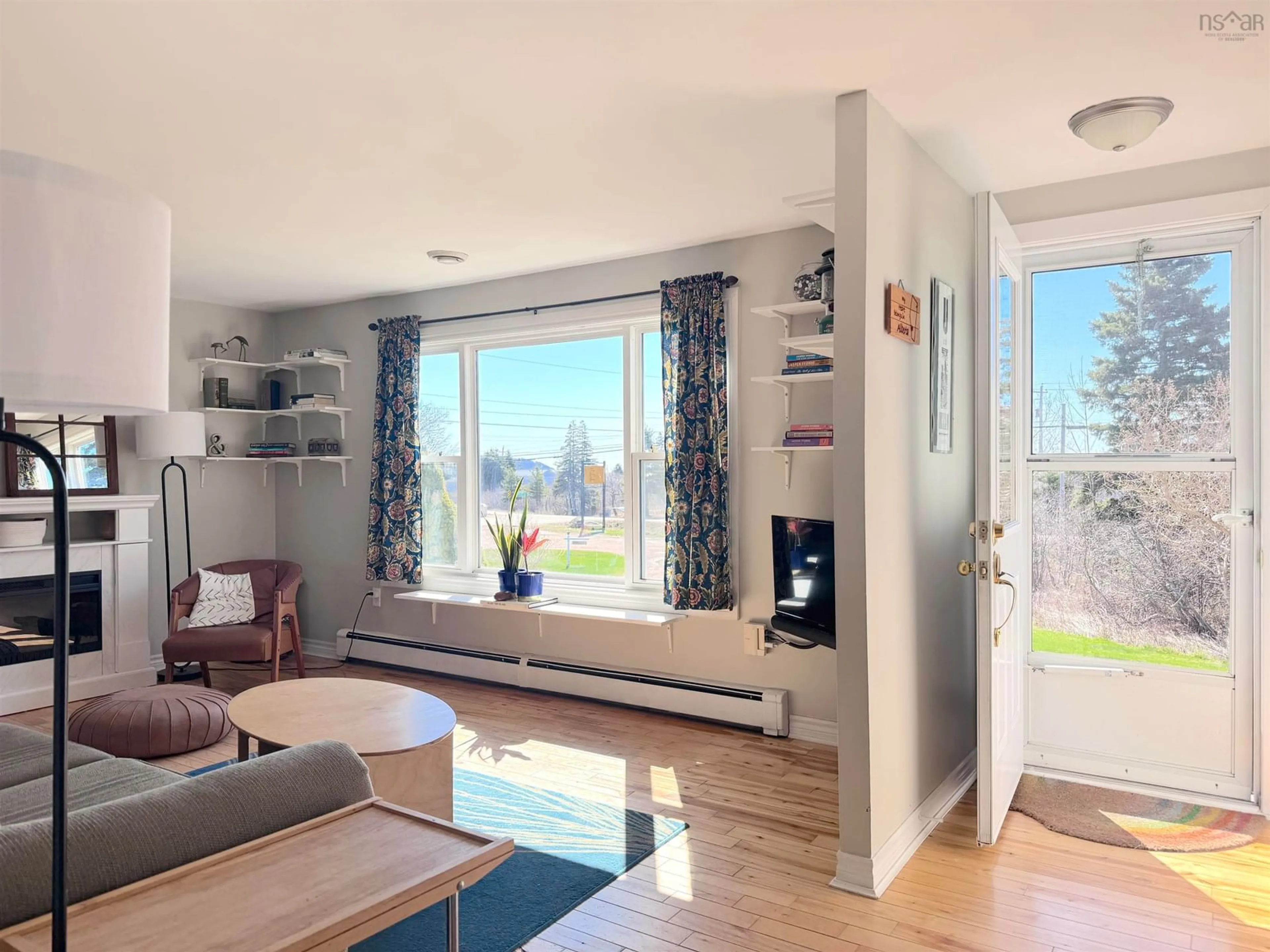 Living room with furniture, wood/laminate floor for 36196 Cabot Trail, Ingonish Nova Scotia B0C 1K0