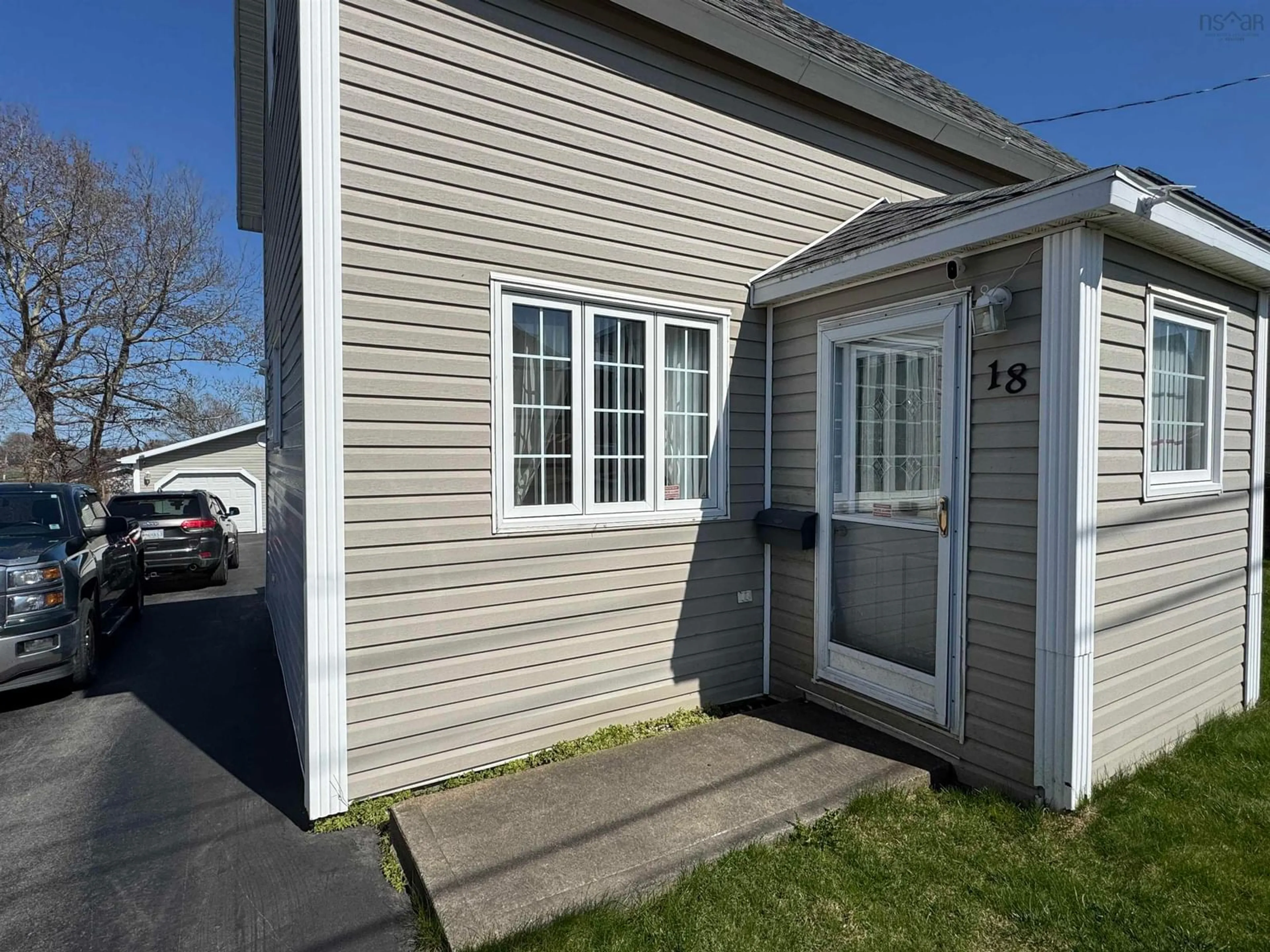 Home with vinyl exterior material, street for 18 Cottage St, Sydney Mines Nova Scotia B1V 2N4