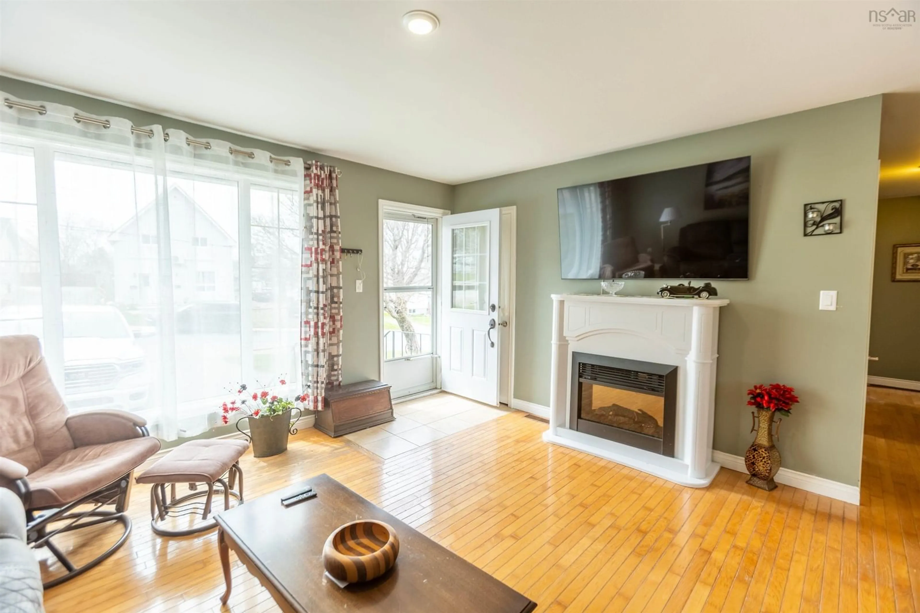 Living room with furniture, wood/laminate floor for 70 Croft St, Amherst Nova Scotia B4H 3A1
