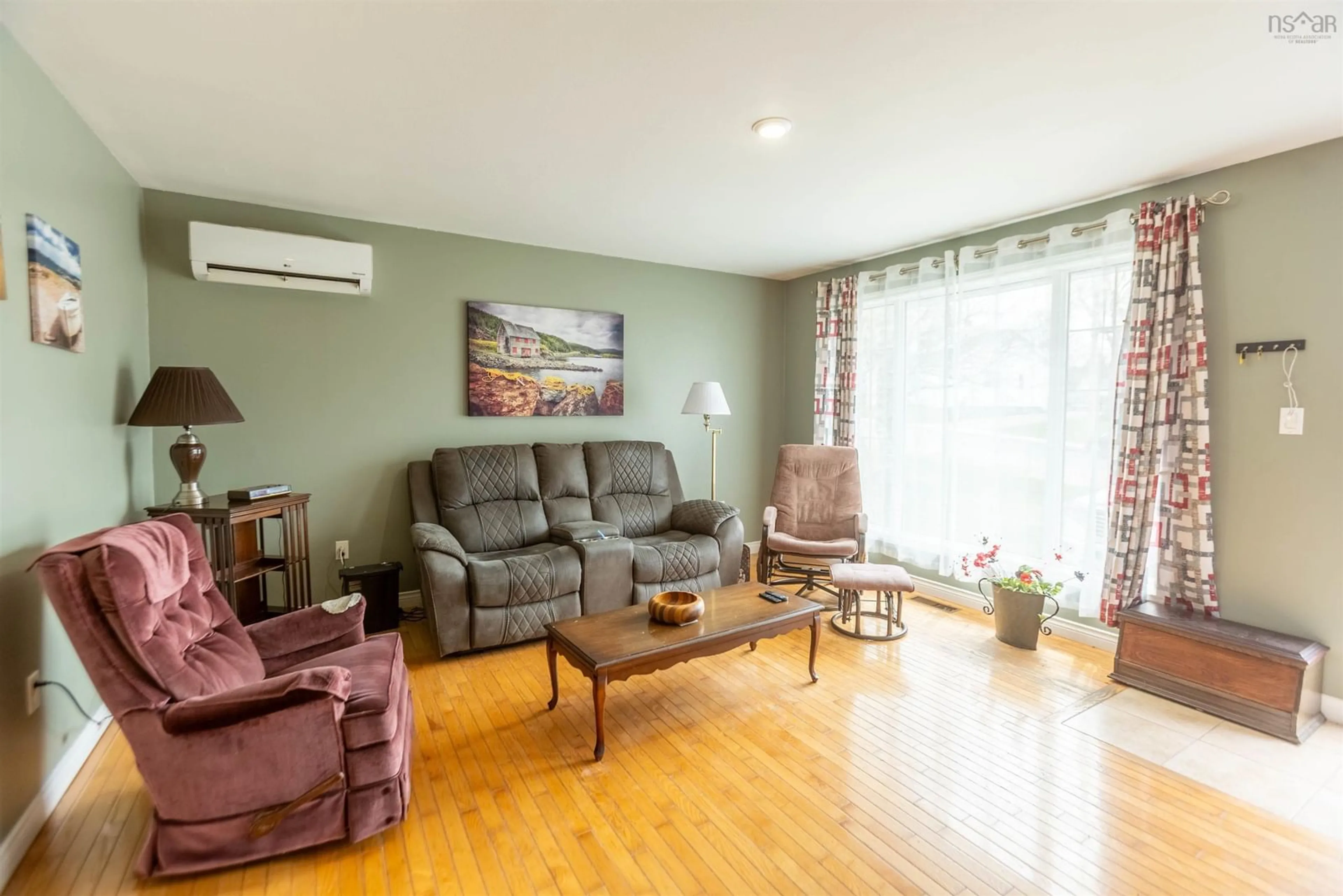 Living room with furniture, wood/laminate floor for 70 Croft St, Amherst Nova Scotia B4H 3A1