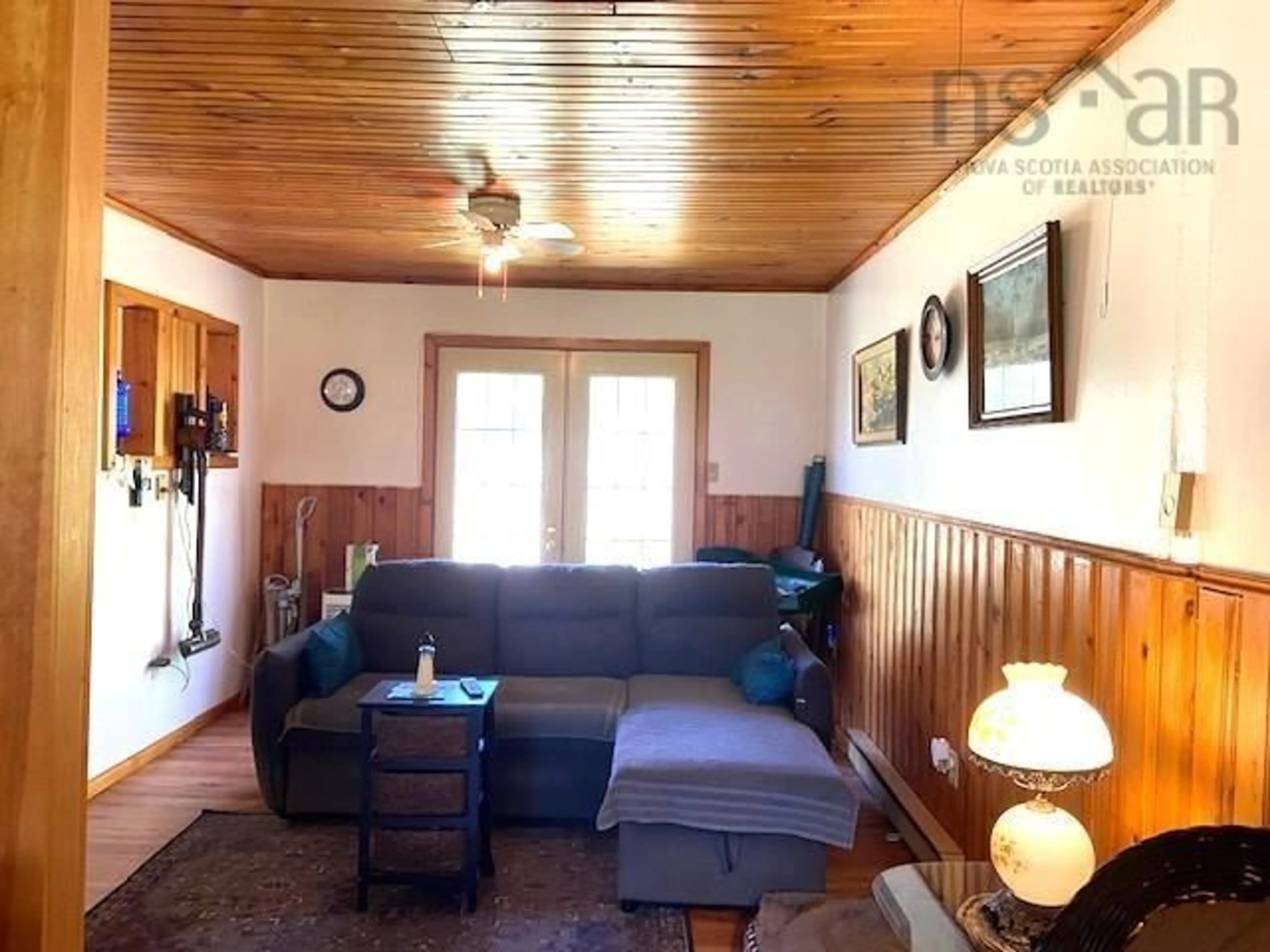 Living room with furniture, wood/laminate floor for 1452 Lake Rd, Sandy Point Nova Scotia B0T 1W0