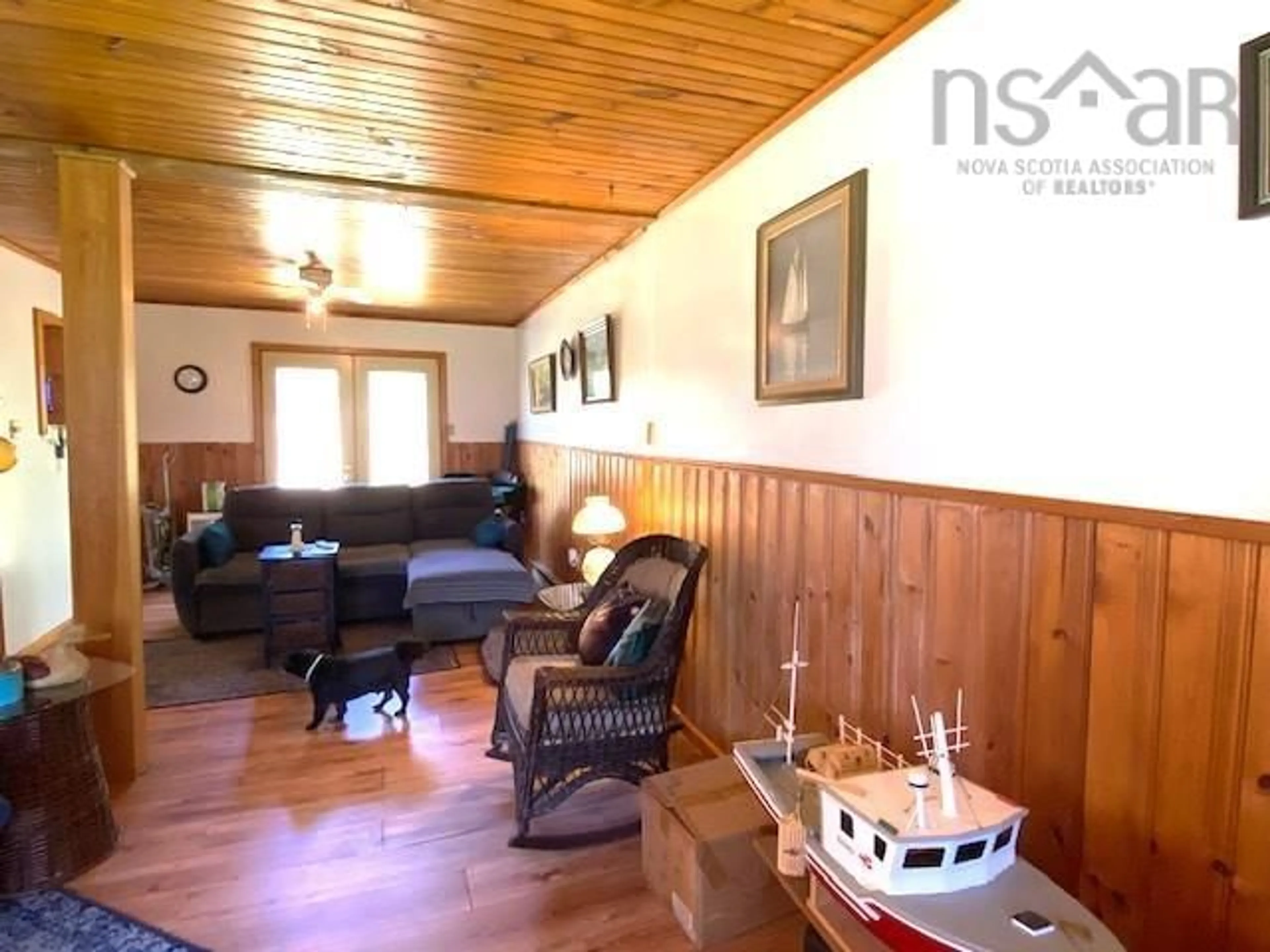 Living room with furniture, wood/laminate floor for 1452 Lake Rd, Sandy Point Nova Scotia B0T 1W0