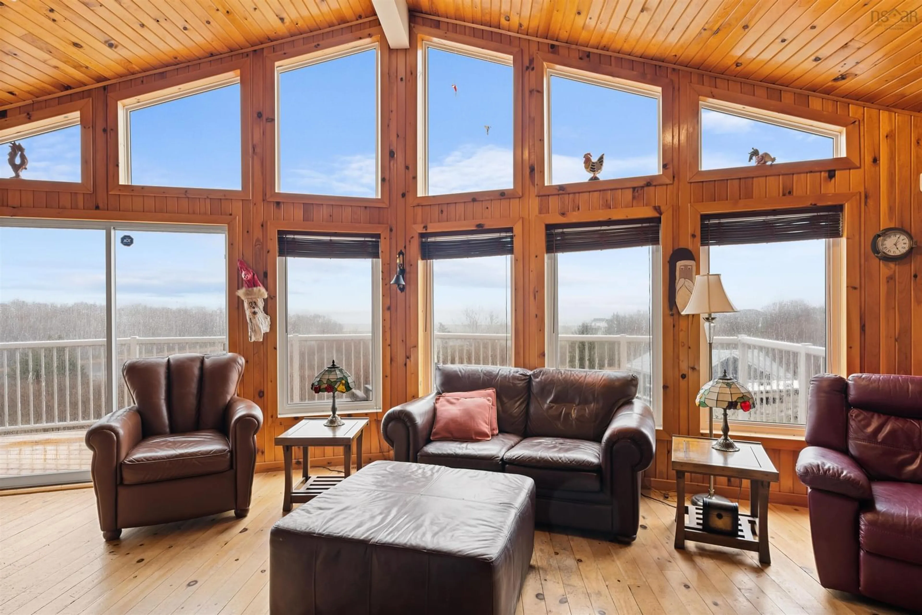Living room with furniture, wood/laminate floor for 39 Blue Heron Dr, Black Point Nova Scotia B0K 1X0