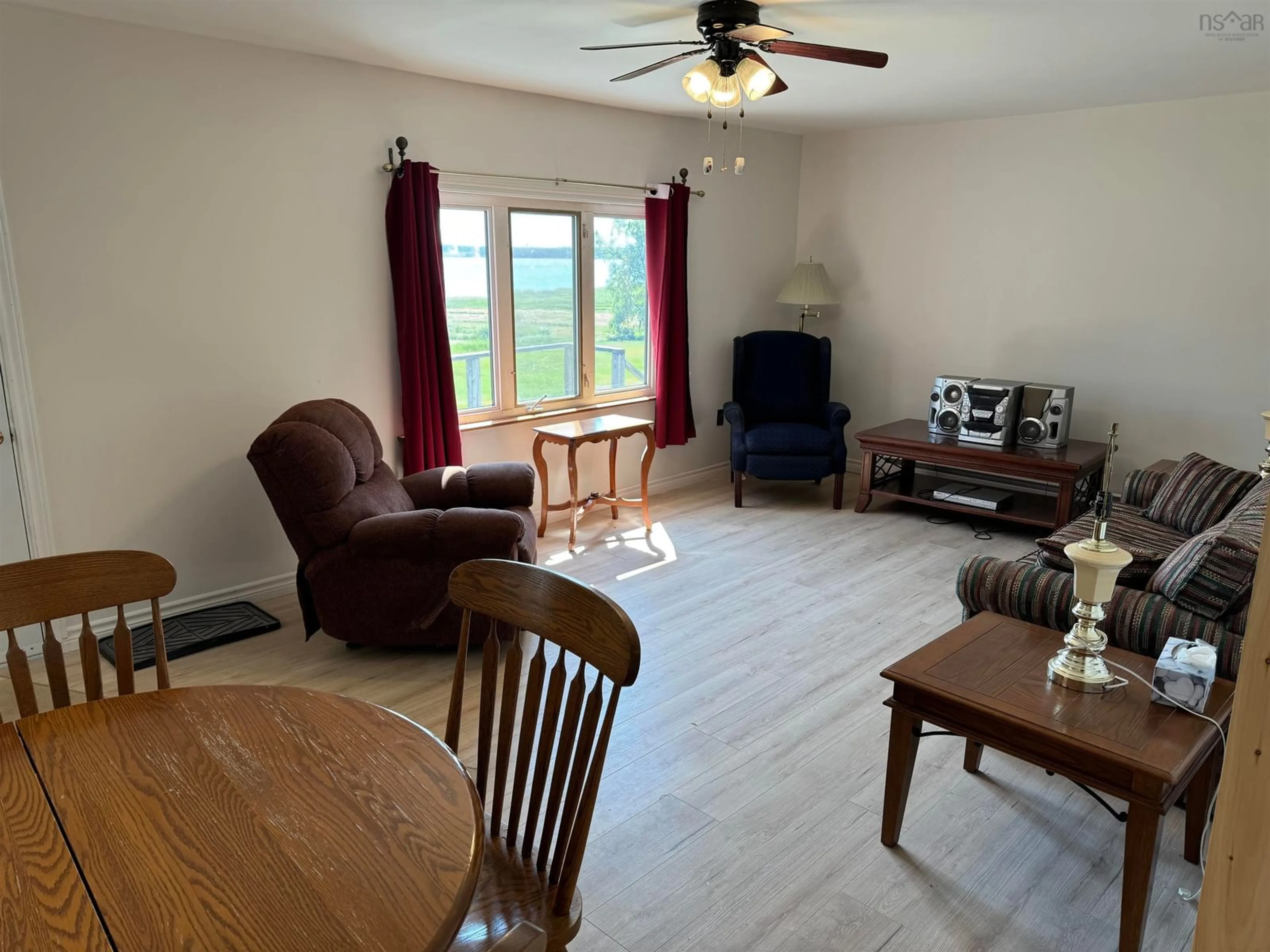 Living room with furniture, wood/laminate floor for 16 Woodside Dr, Waterside Nova Scotia B0K 1H0
