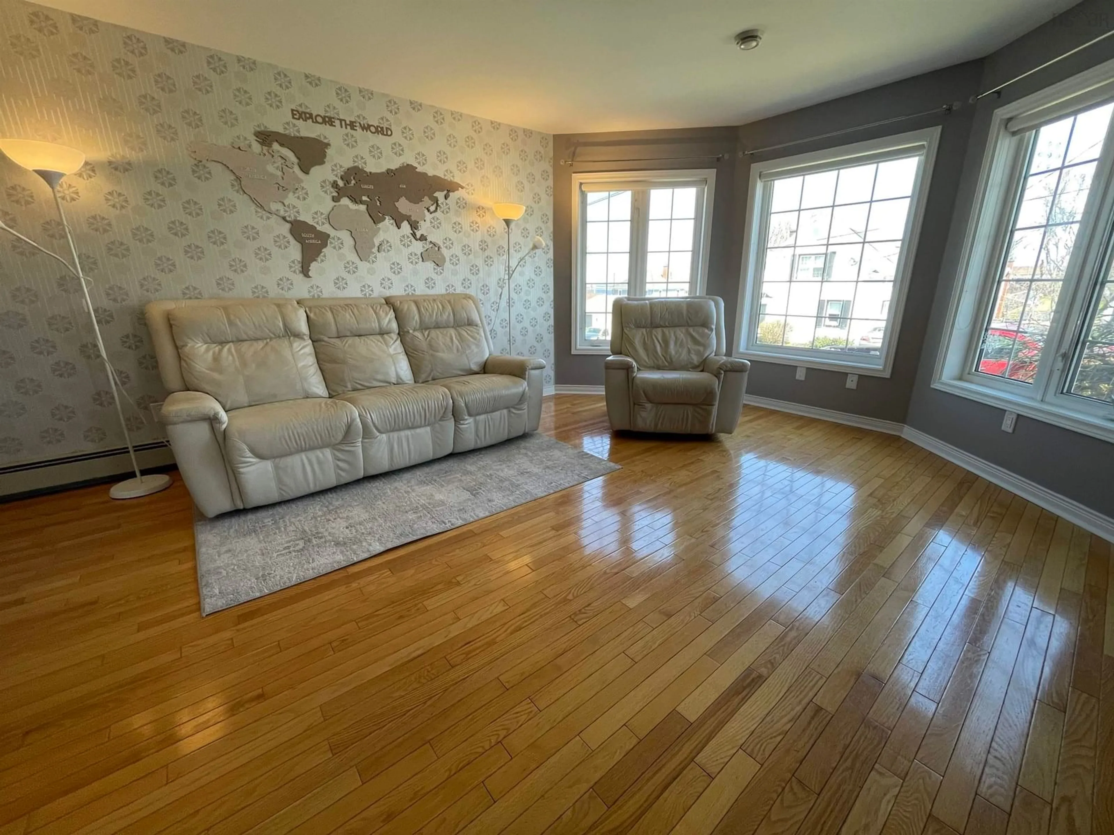Living room with furniture, wood/laminate floor for 86 Castle Dr, Sydney Nova Scotia B1S 2A4