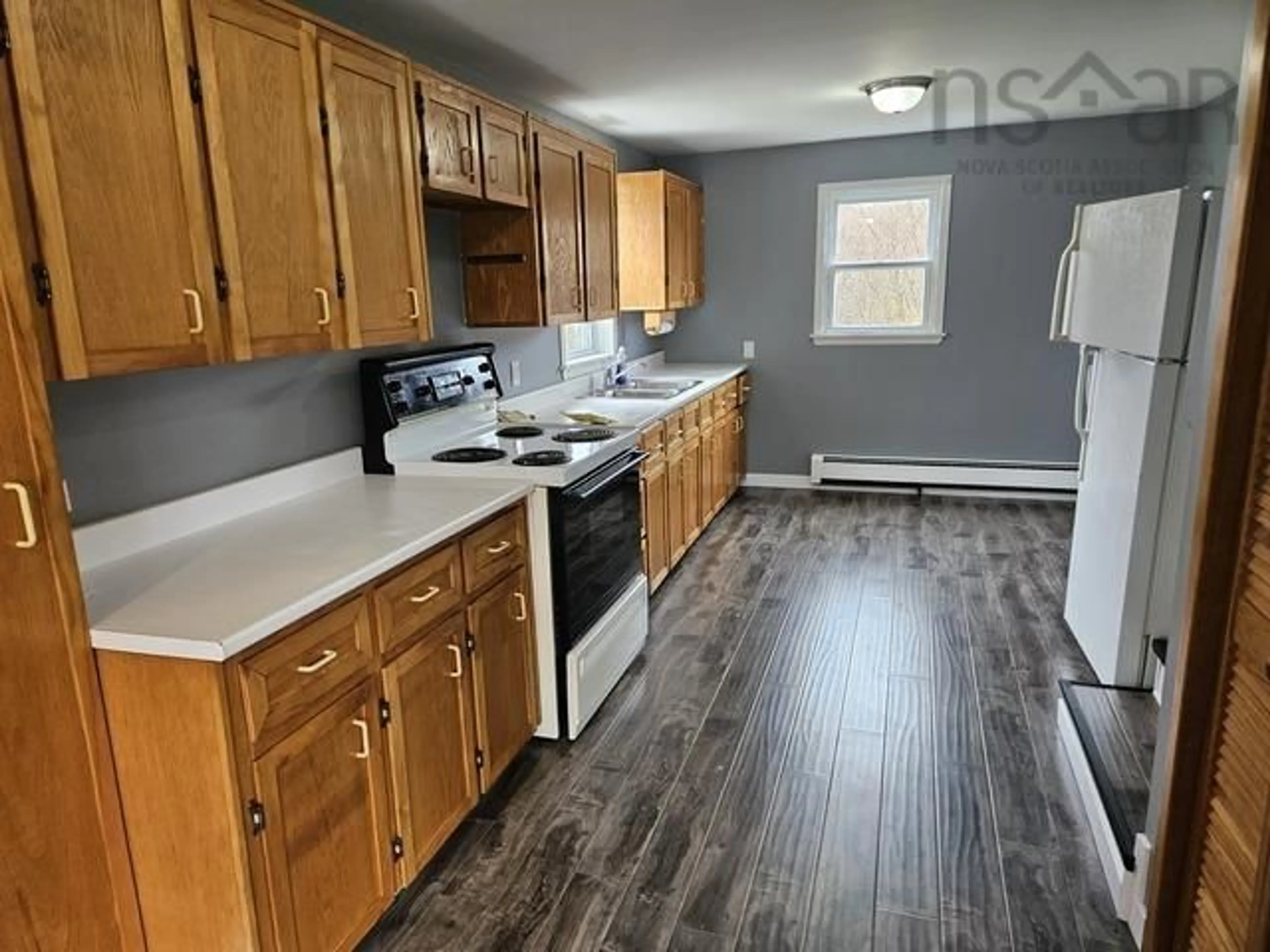 Kitchen with laundary machines, wood/laminate floor for 482 Hwy 335, West Pubnico Nova Scotia B0W 3S0