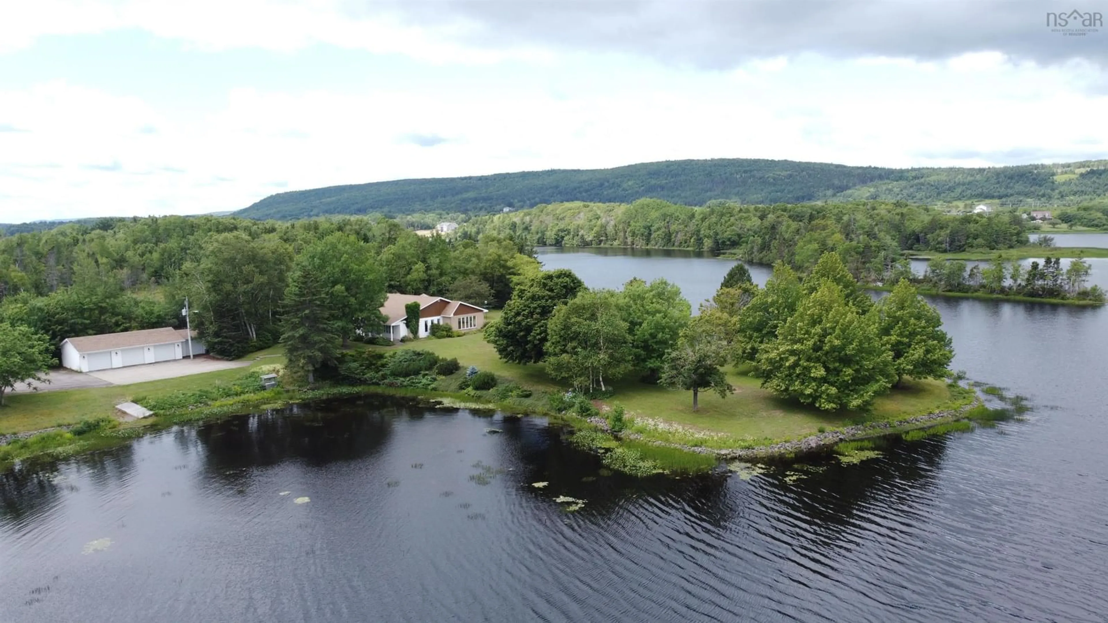 A pic from outside/outdoor area/front of a property/back of a property/a pic from drone, water/lake/river/ocean view for 1900 Kings Rd, Sydney River Nova Scotia B1P 6H1