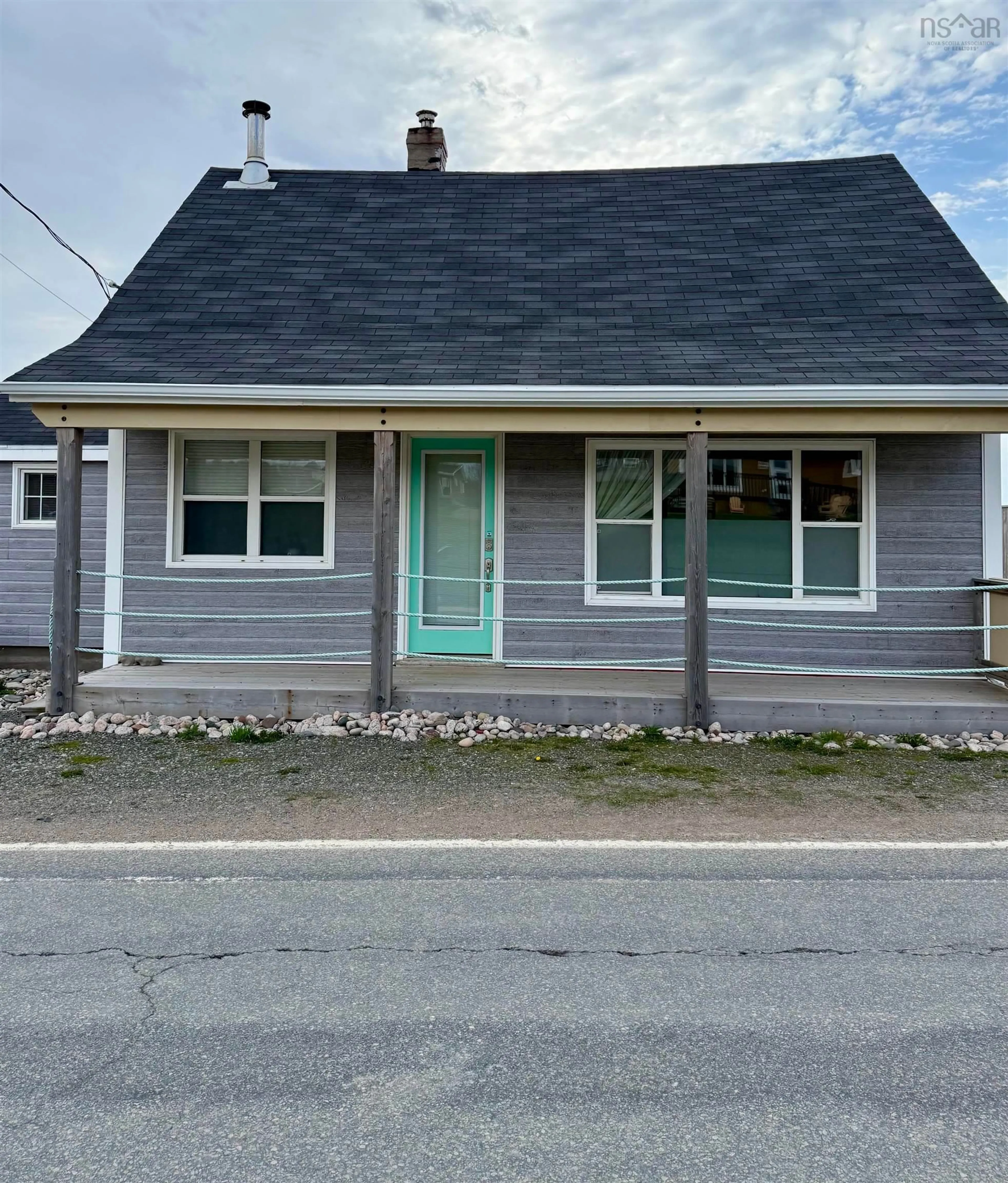Home with vinyl exterior material, street for 15491 Cabot Trail Rd, Chéticamp Nova Scotia B0E 1H0