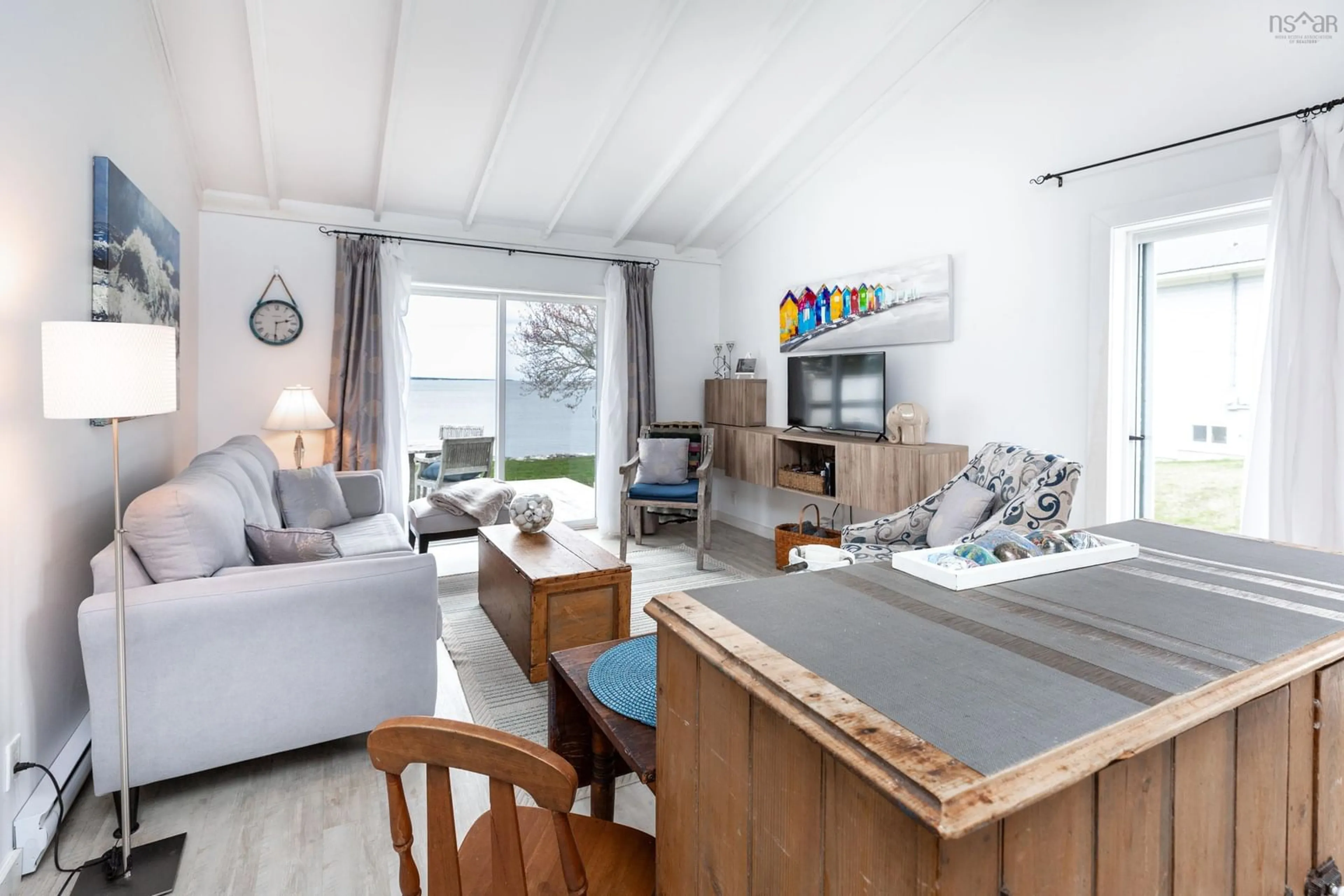 Living room with furniture, wood/laminate floor for 121 Carters Beach Rd, Port Mouton Nova Scotia B0T 1T0