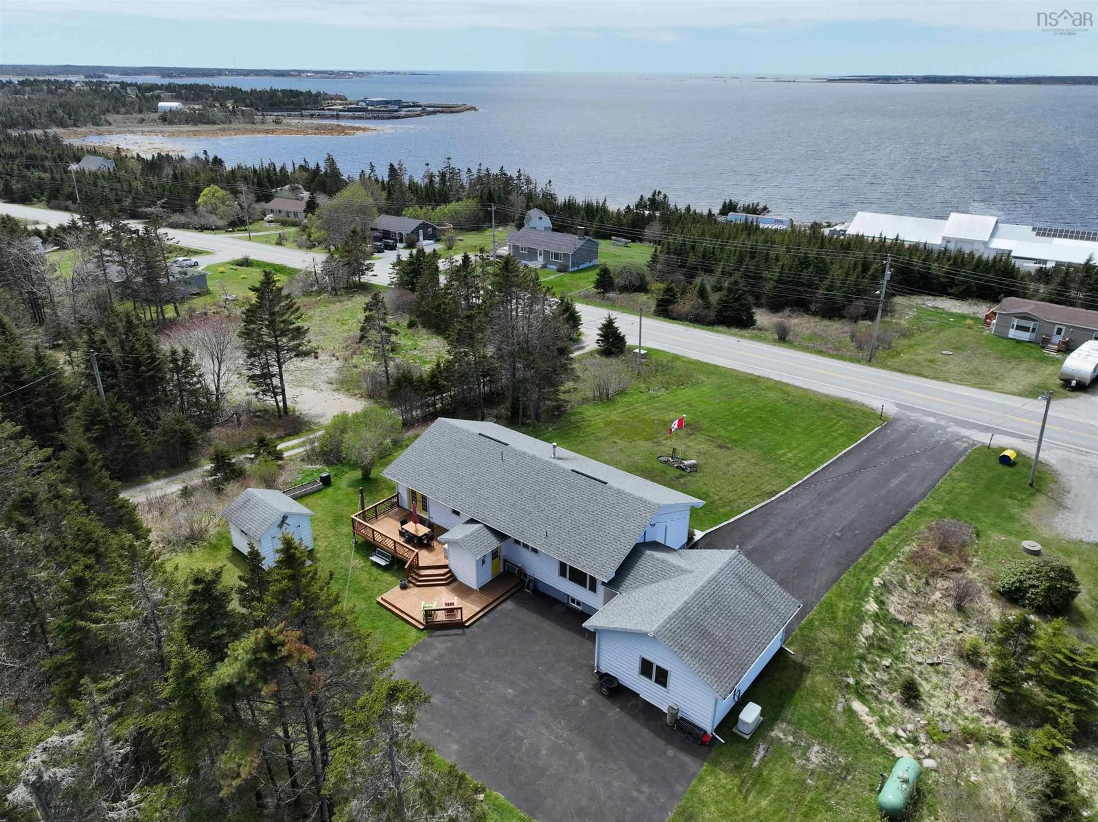 A pic from outside/outdoor area/front of a property/back of a property/a pic from drone, water/lake/river/ocean view for 521 330 Hwy, North East Point Nova Scotia B0W 2P0