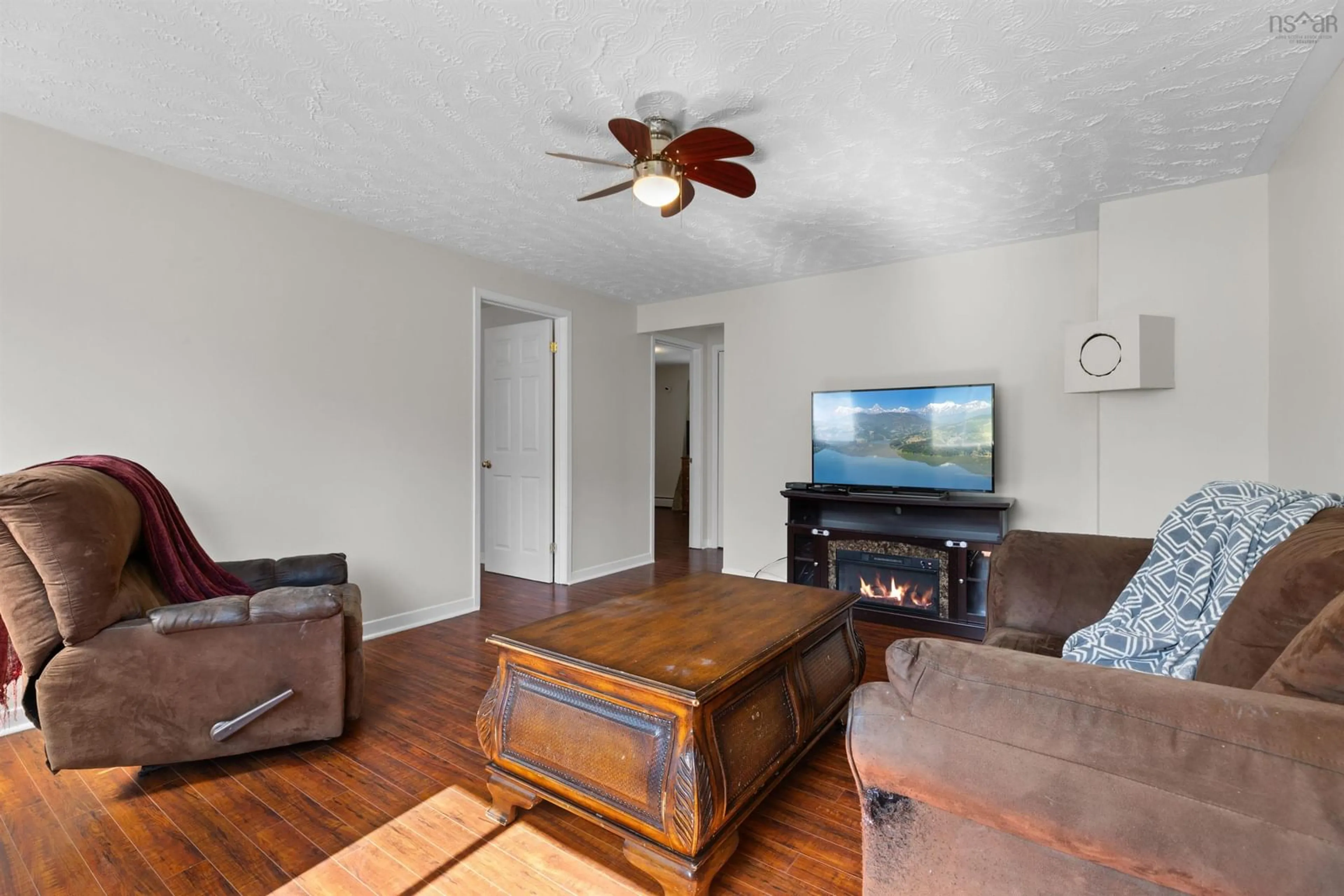 Living room with furniture, wood/laminate floor for 2829 Prospect Rd, Whites Lake Nova Scotia B3T 1V8