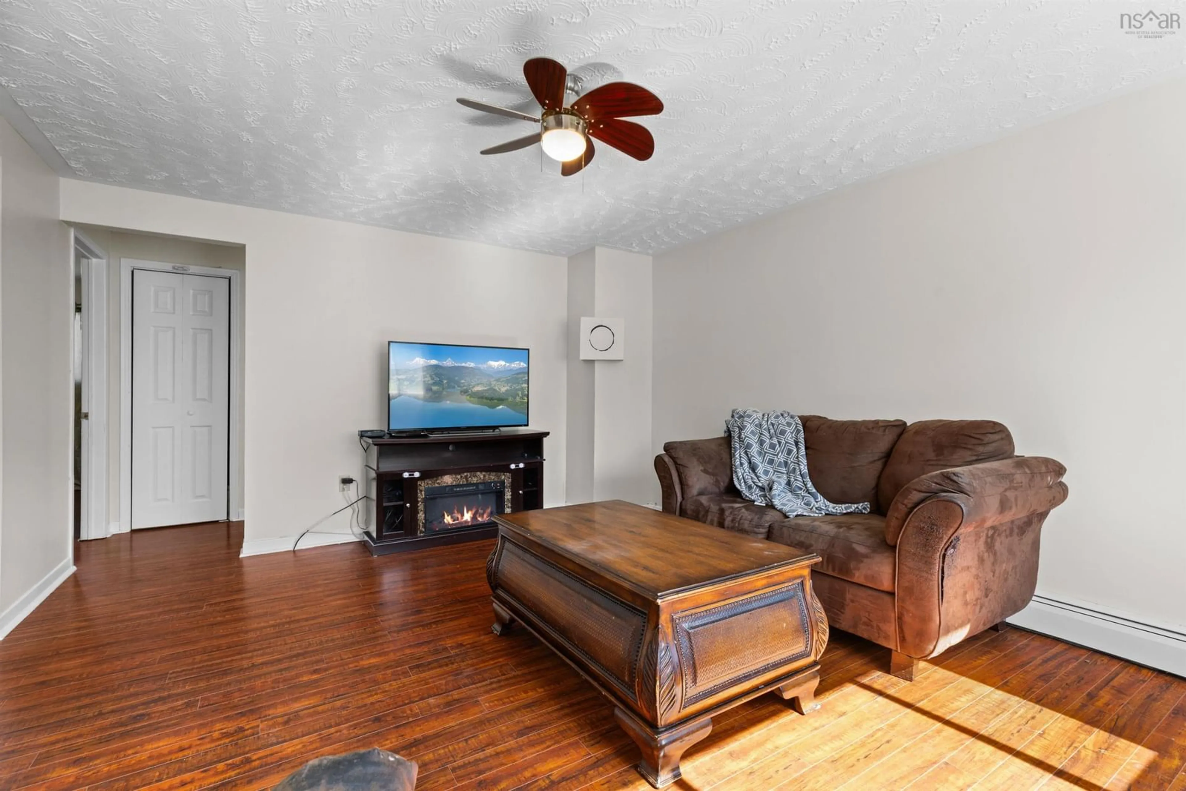 Living room with furniture, wood/laminate floor for 2829 Prospect Rd, Whites Lake Nova Scotia B3T 1V8