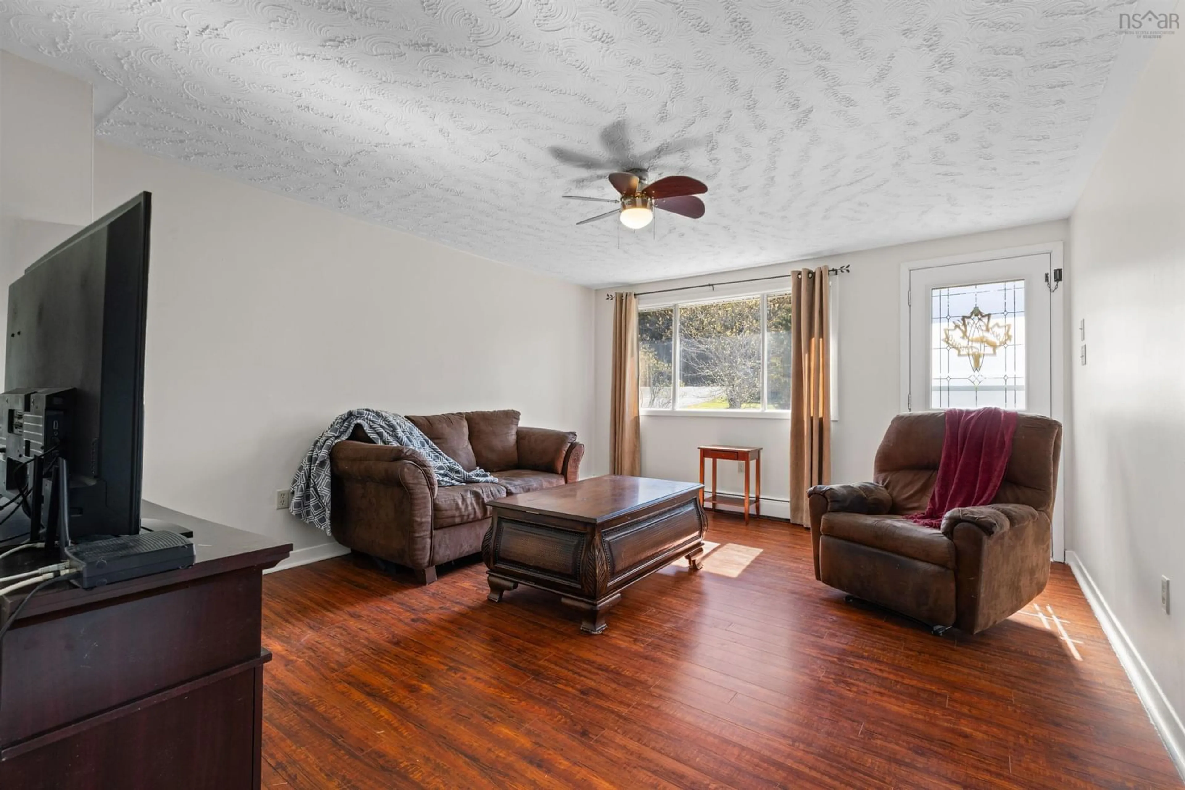 Living room with furniture, wood/laminate floor for 2829 Prospect Rd, Whites Lake Nova Scotia B3T 1V8