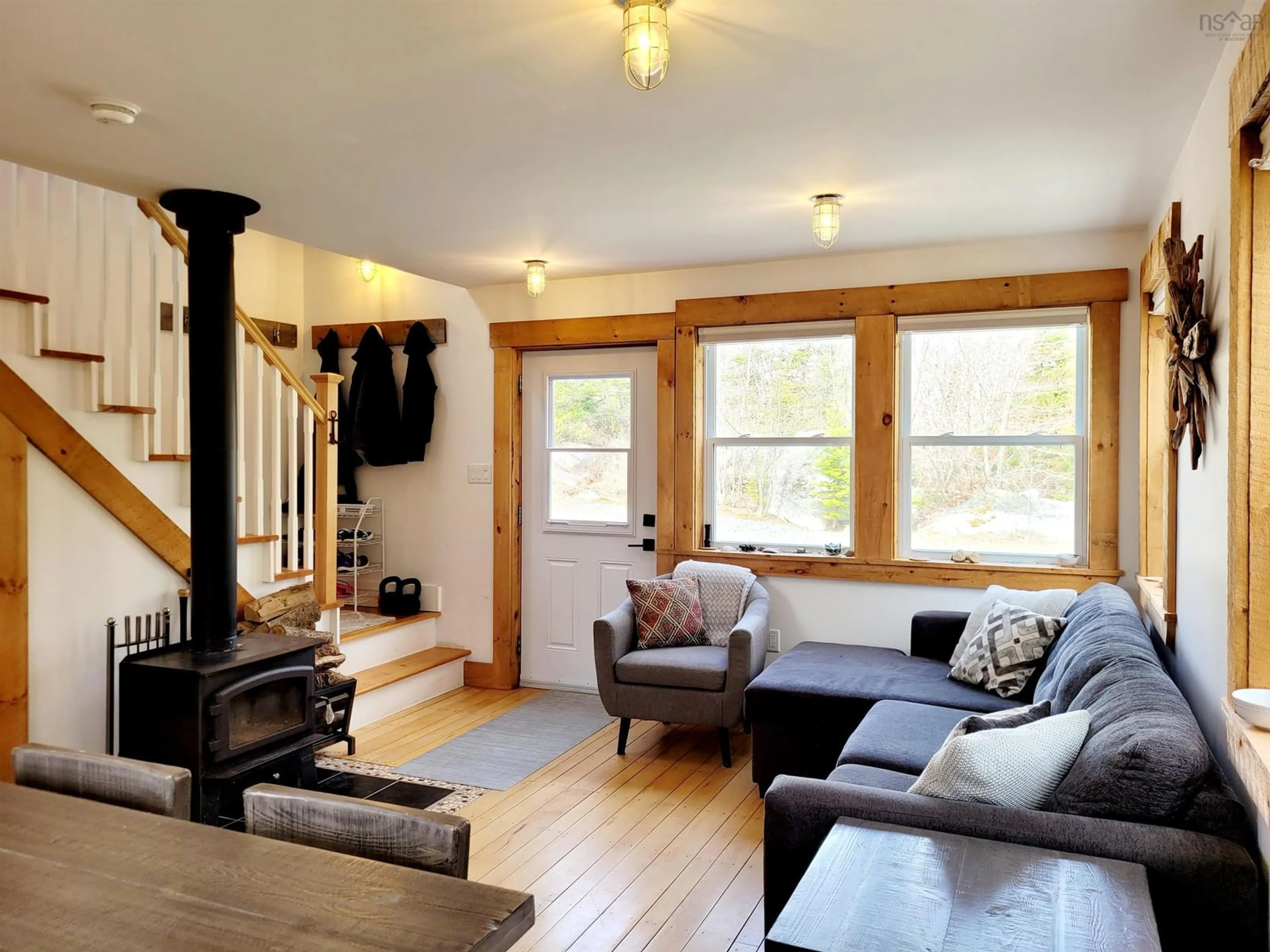 Living room with furniture, wood/laminate floor for 83 Golden Horizon Dr, South West Port Mouton Nova Scotia B0T 1T0