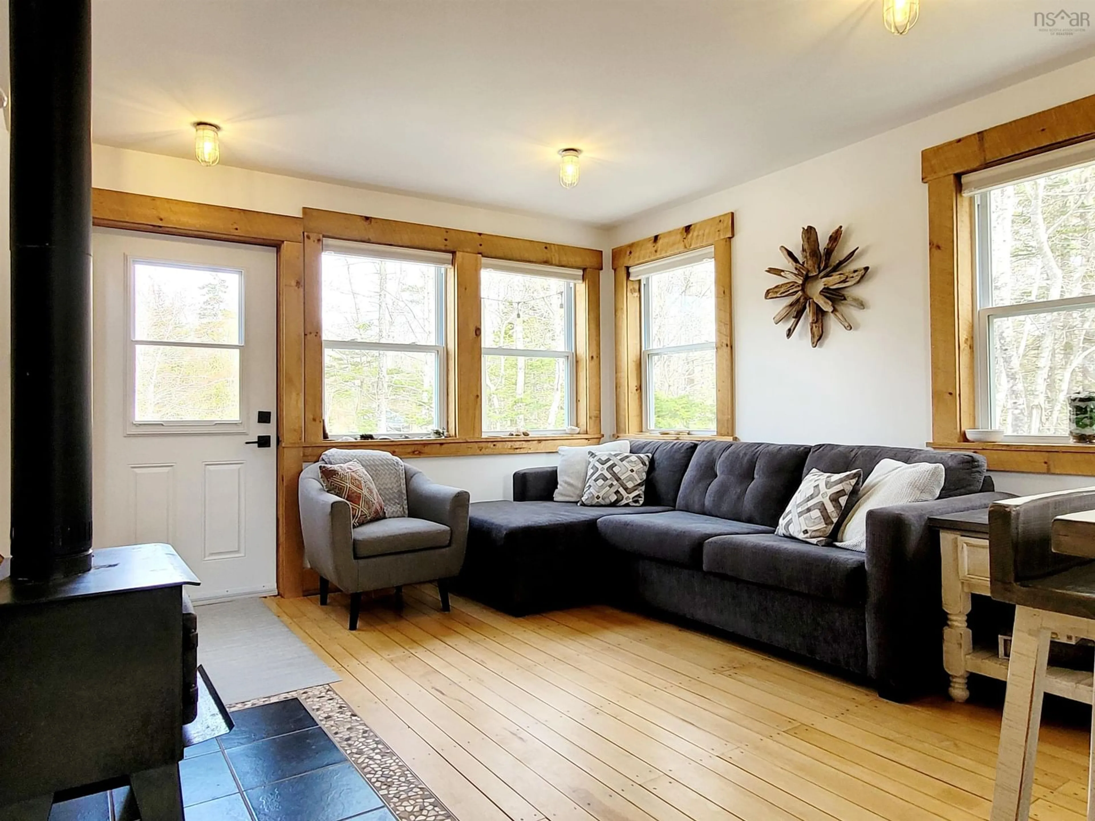 Living room with furniture, wood/laminate floor for 83 Golden Horizon Dr, South West Port Mouton Nova Scotia B0T 1T0