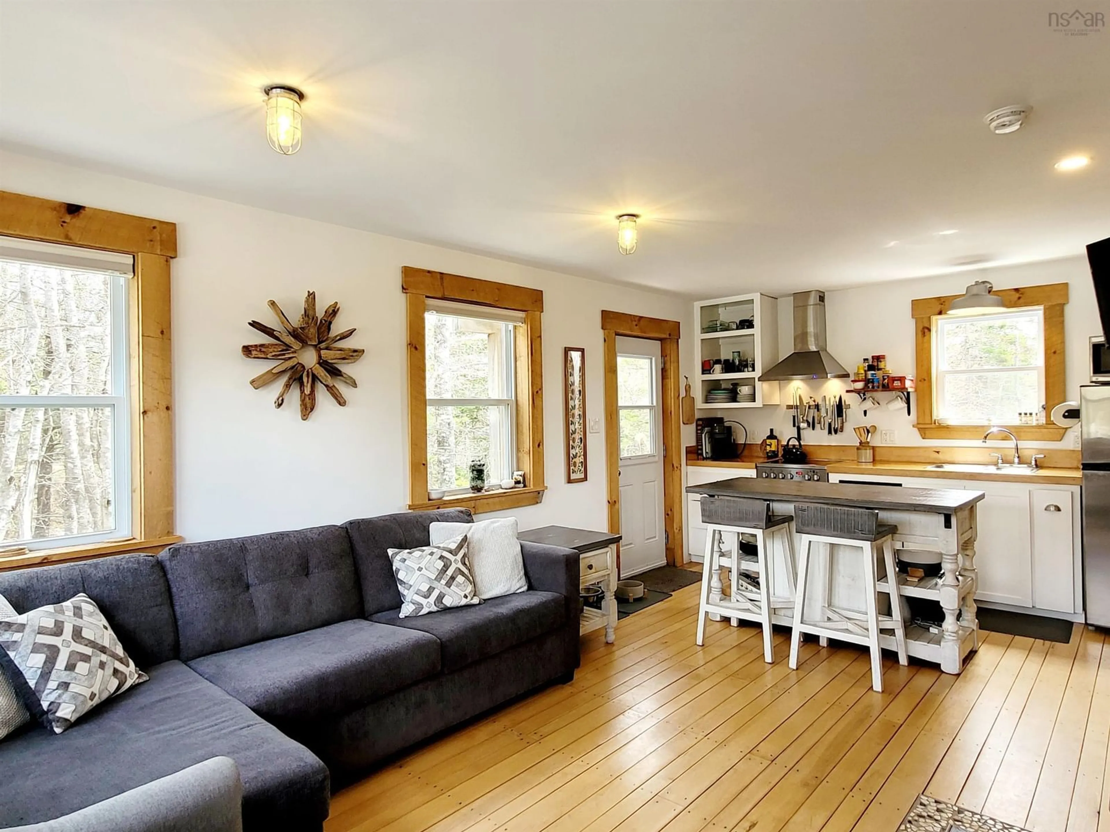 Living room with furniture, wood/laminate floor for 83 Golden Horizon Dr, South West Port Mouton Nova Scotia B0T 1T0