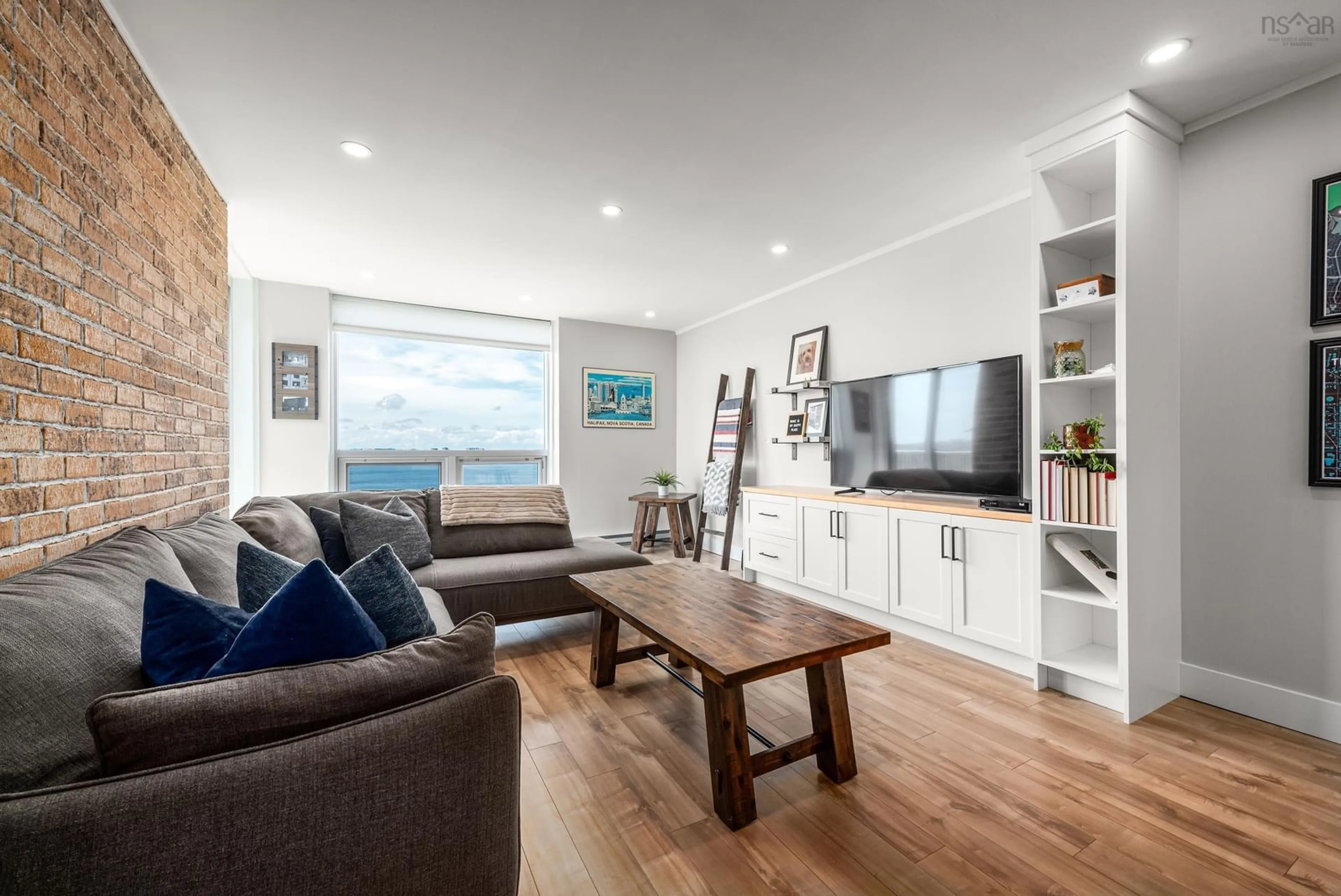 Living room with furniture, wood/laminate floor for 5572 North Ridge Rd #PH8, Halifax Peninsula Nova Scotia B3K 5K2