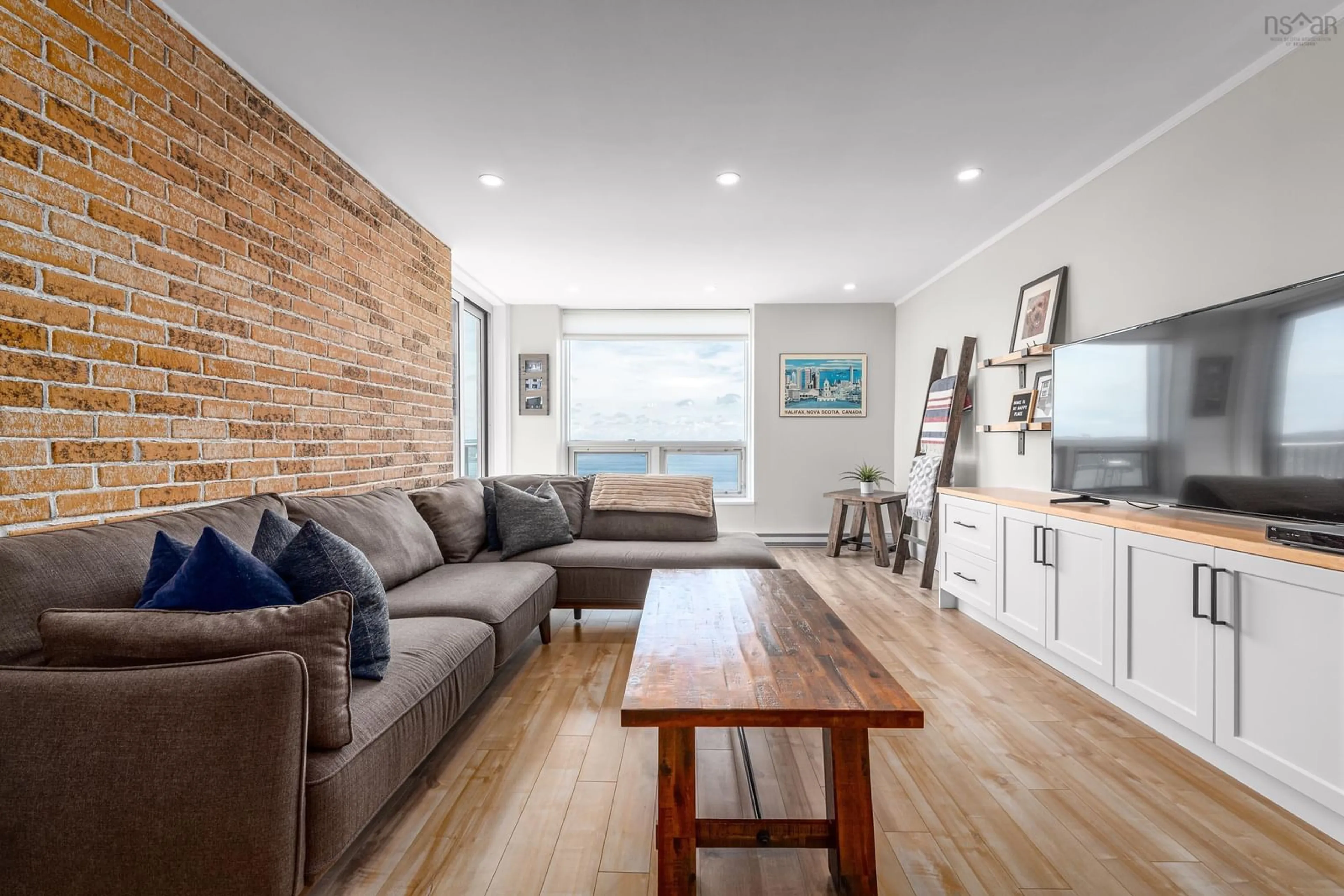 Living room with furniture, wood/laminate floor for 5572 North Ridge Rd #PH8, Halifax Peninsula Nova Scotia B3K 5K2