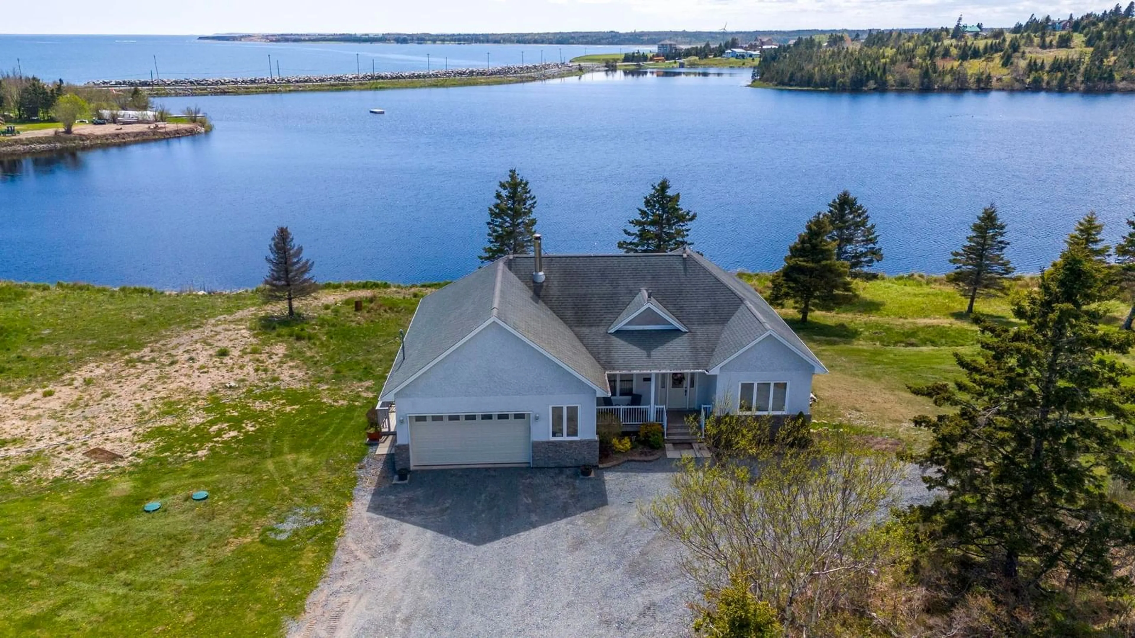 A pic from outside/outdoor area/front of a property/back of a property/a pic from drone, water/lake/river/ocean view for 1480 Cow Bay Rd, Cow Bay Nova Scotia B3G 1L3