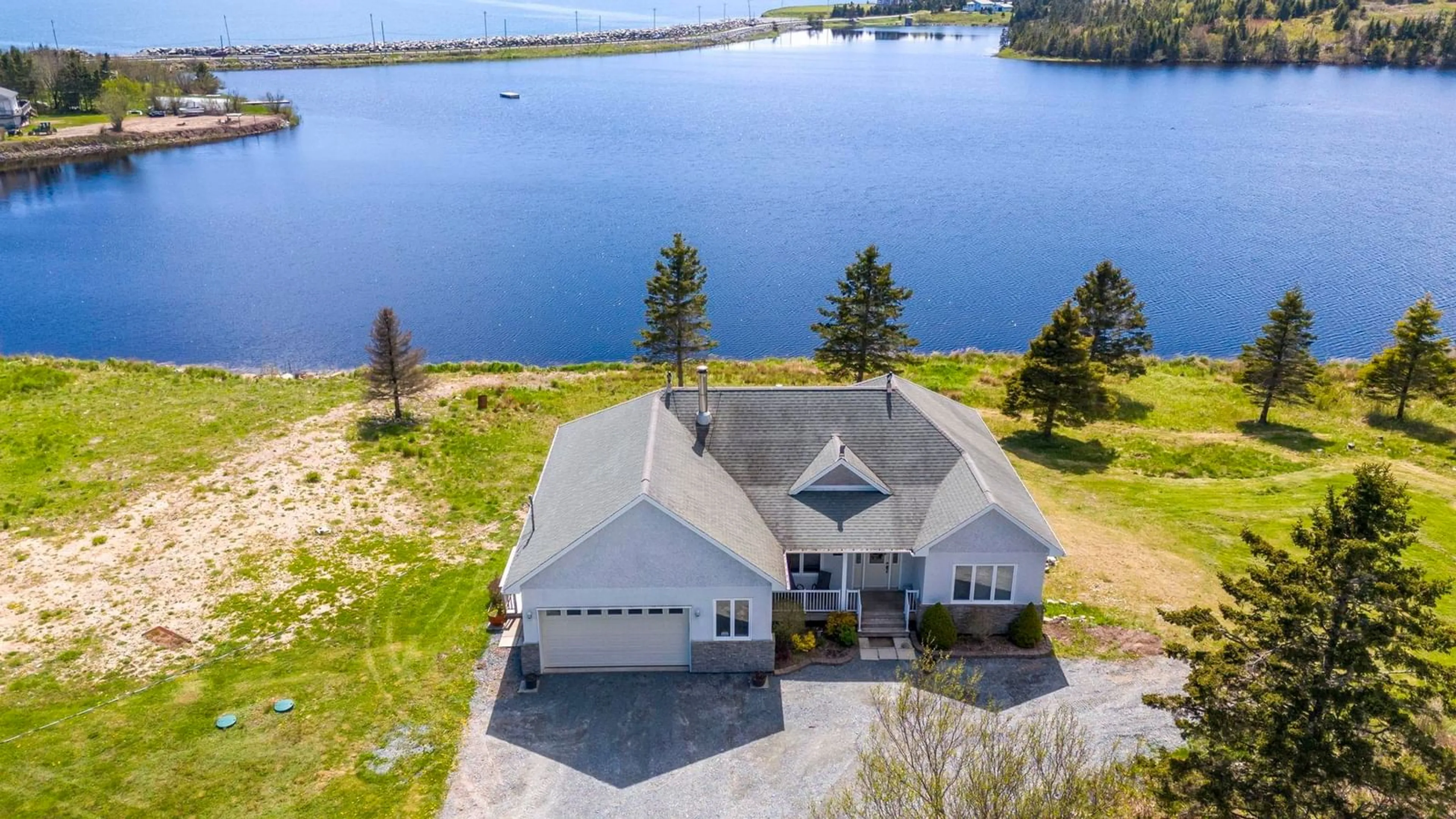 A pic from outside/outdoor area/front of a property/back of a property/a pic from drone, water/lake/river/ocean view for 1480 Cow Bay Rd, Cow Bay Nova Scotia B3G 1L3