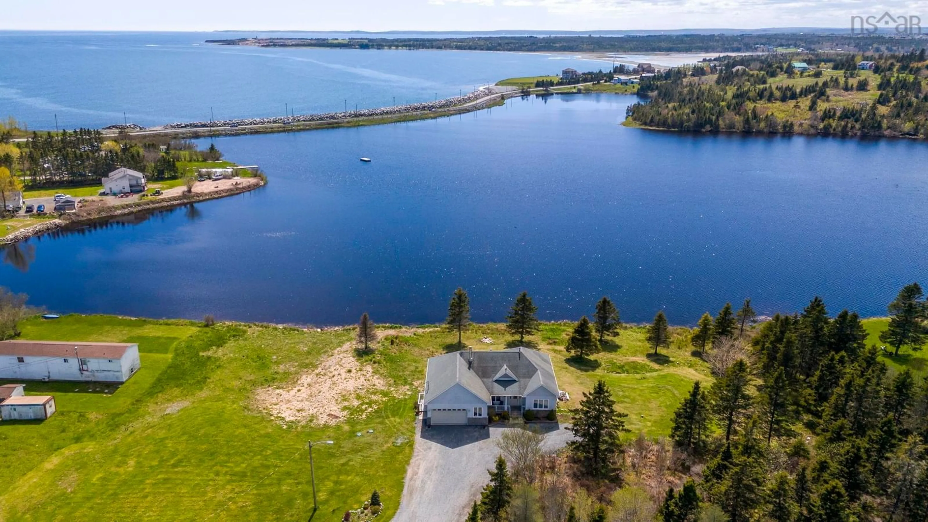 A pic from outside/outdoor area/front of a property/back of a property/a pic from drone, water/lake/river/ocean view for 1480 Cow Bay Rd, Cow Bay Nova Scotia B3G 1L3