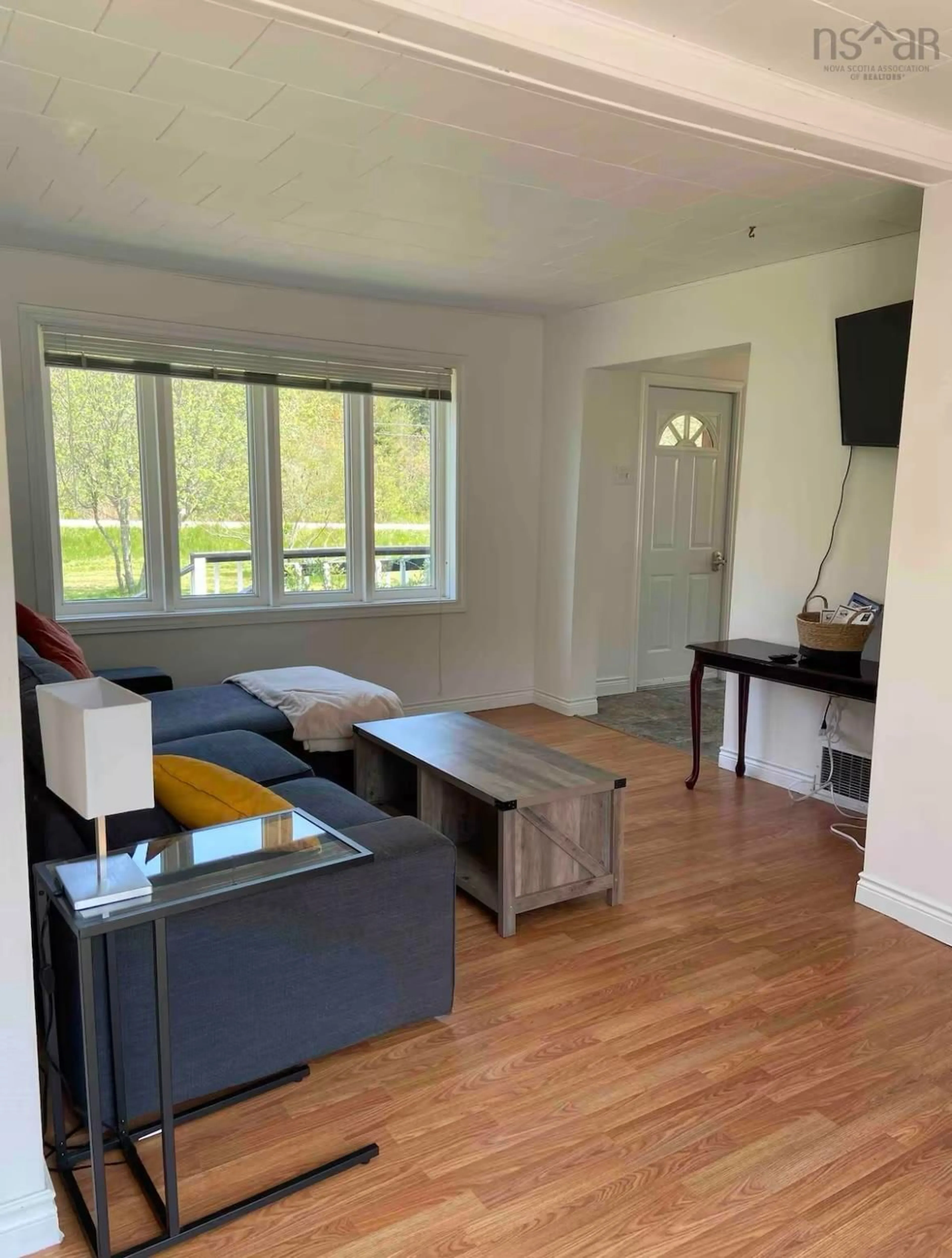 Living room with furniture, wood/laminate floor for 16547 316 Hwy, Country Harbour Nova Scotia B0H 1J0